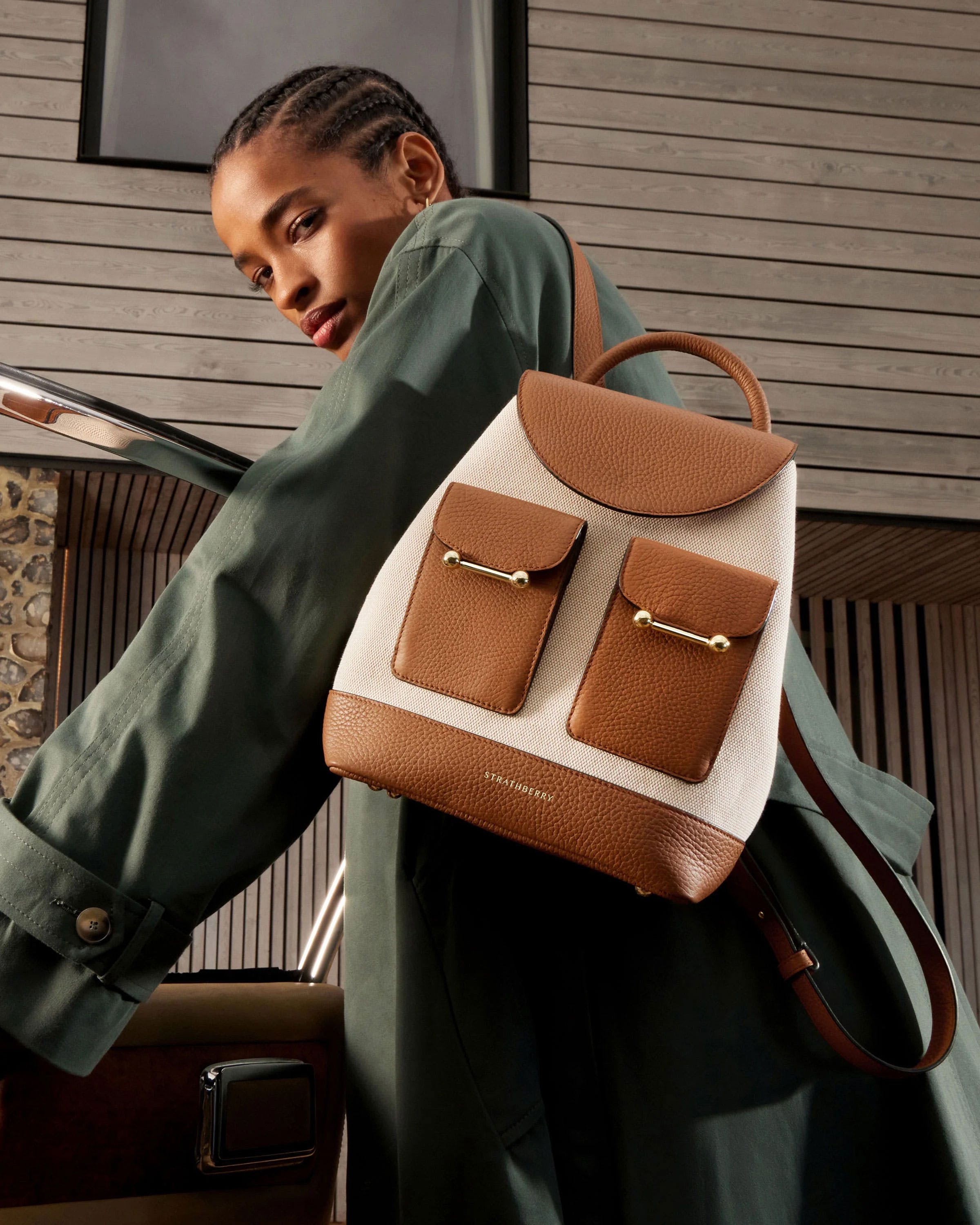 A woman carrying a brown and white backpack