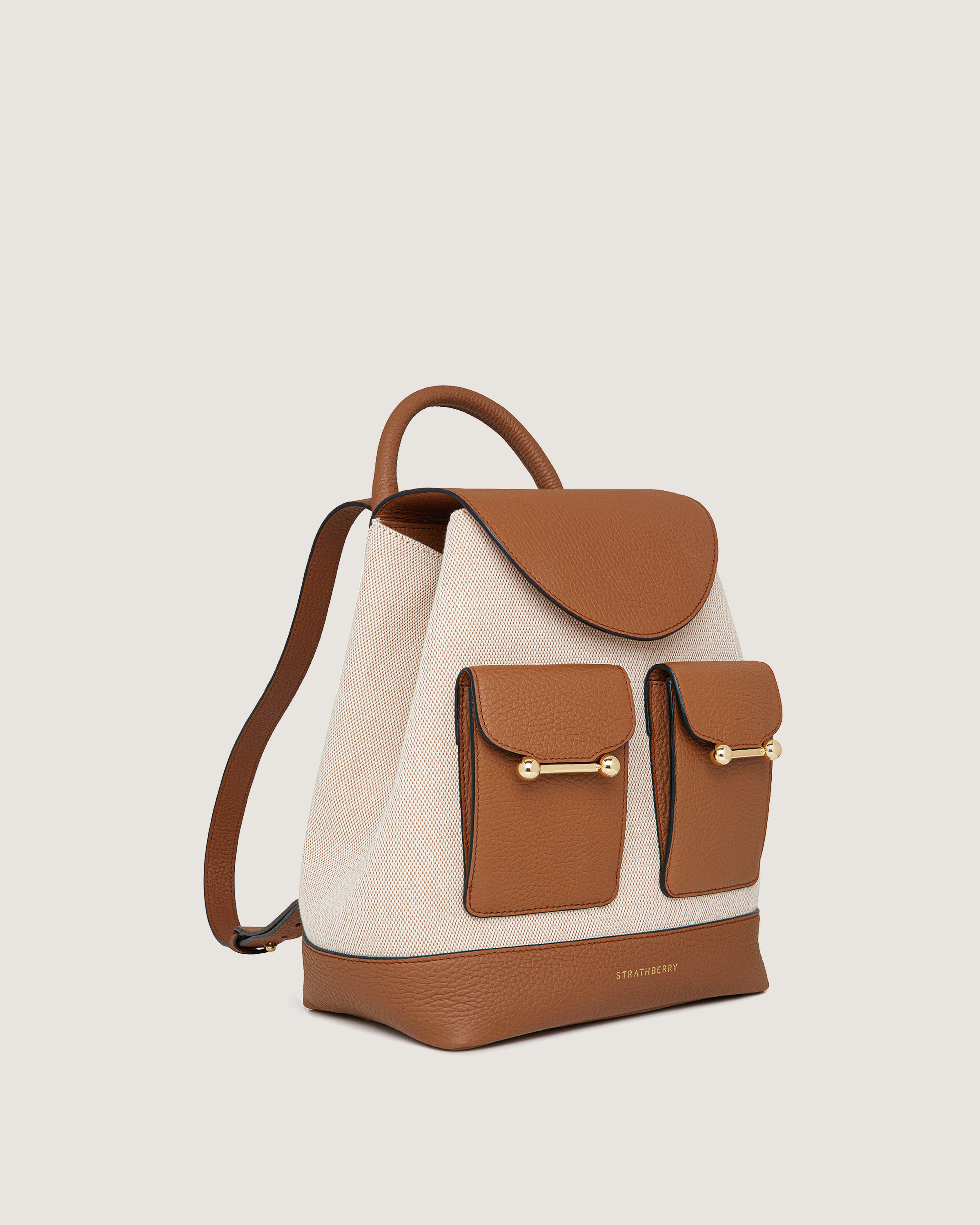 A brown and white handbag with two pockets