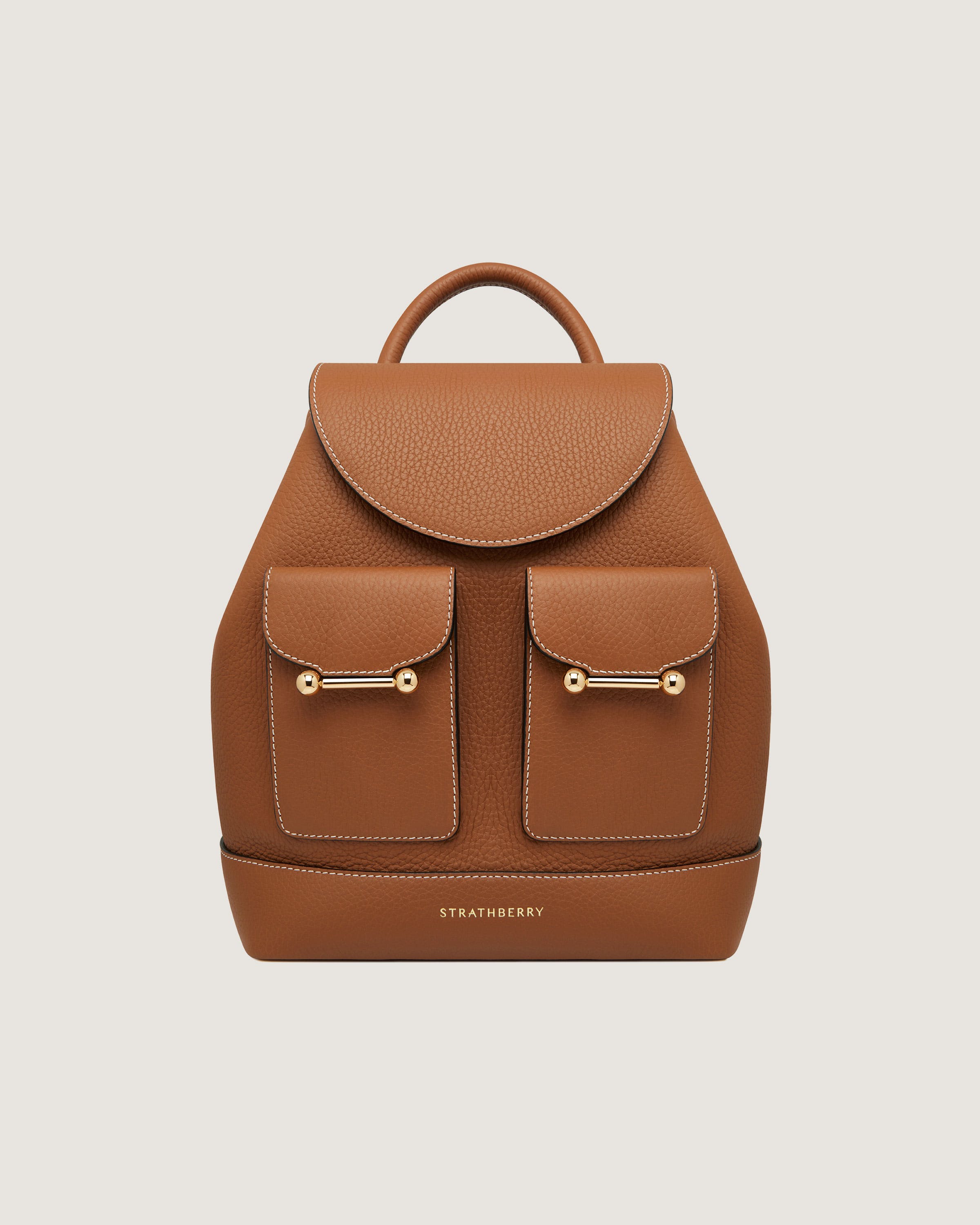 A tan leather backpack with two pockets