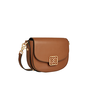 A brown cross body bag on a green background