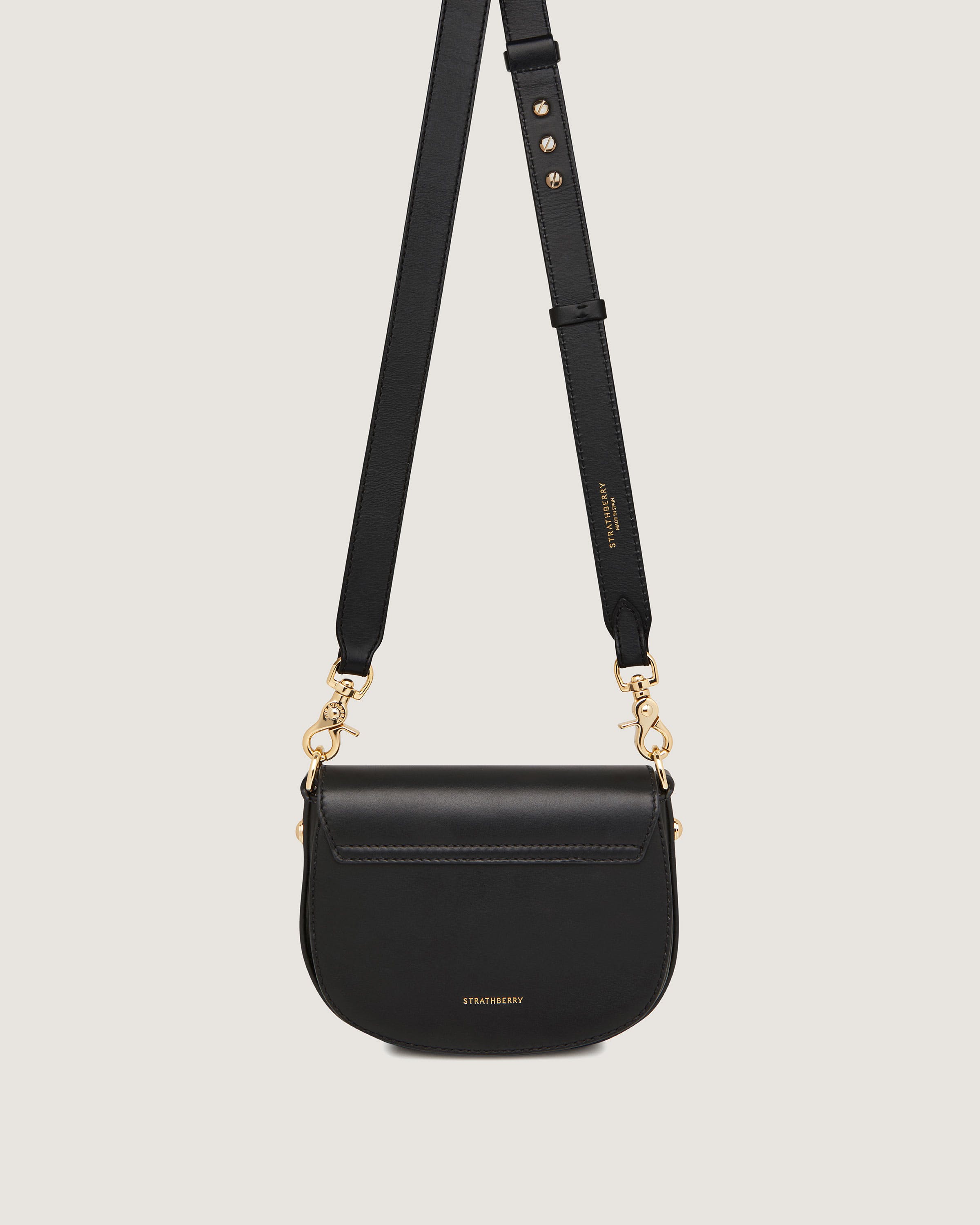 A black cross body bag on a white background