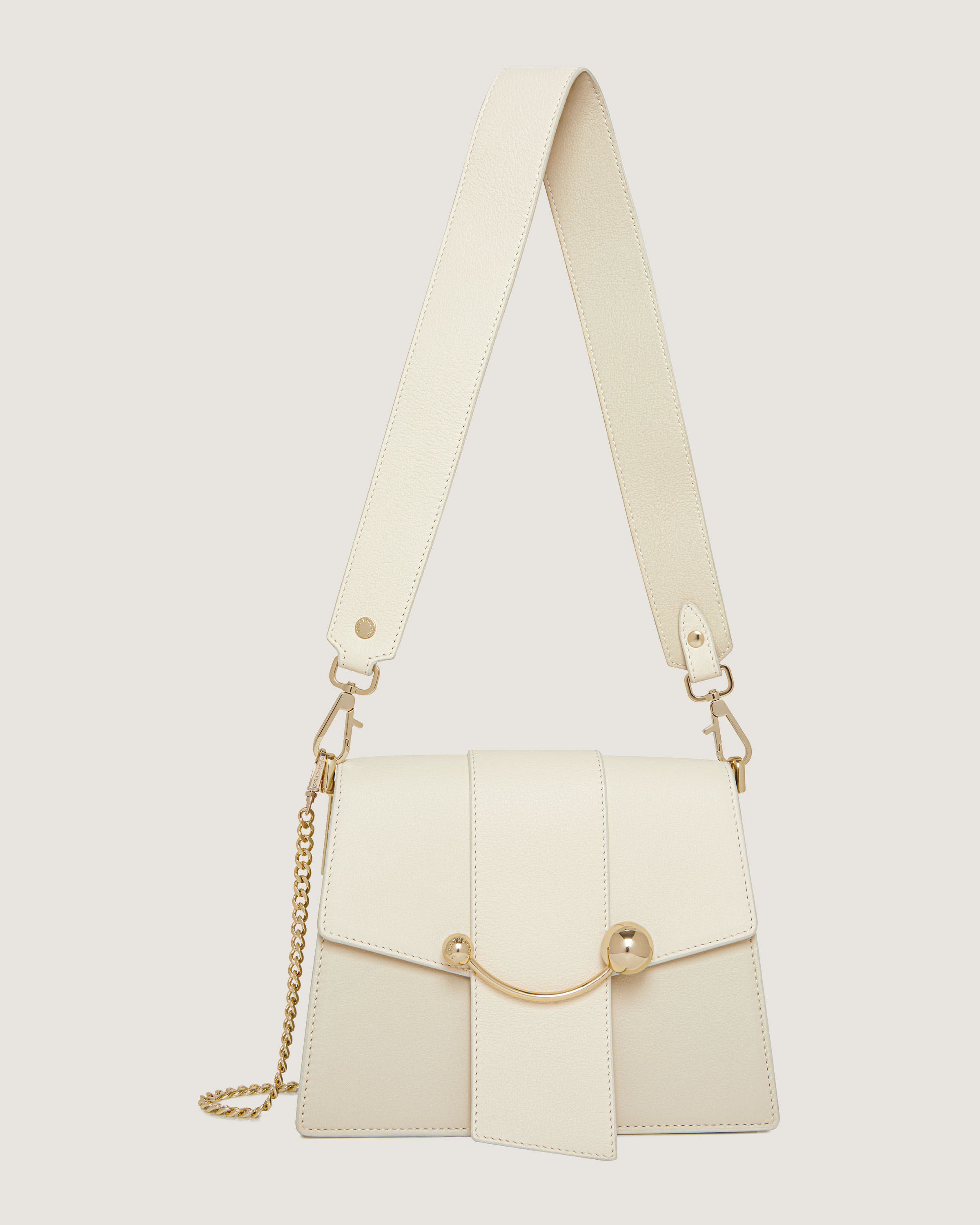 A white purse with a chain hanging from it