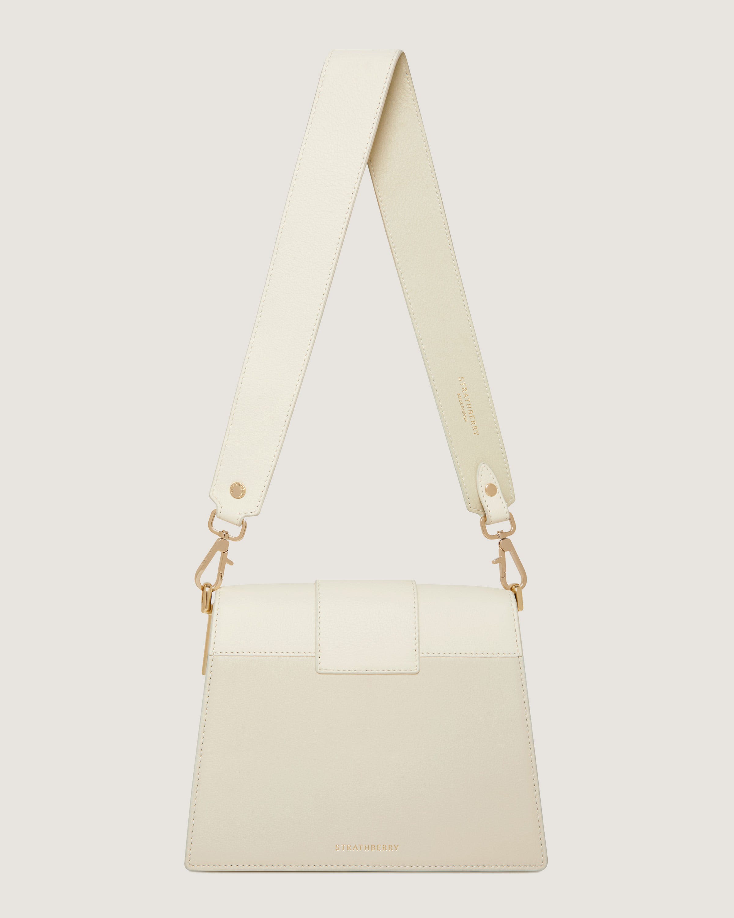 A white bag with a strap hanging from it