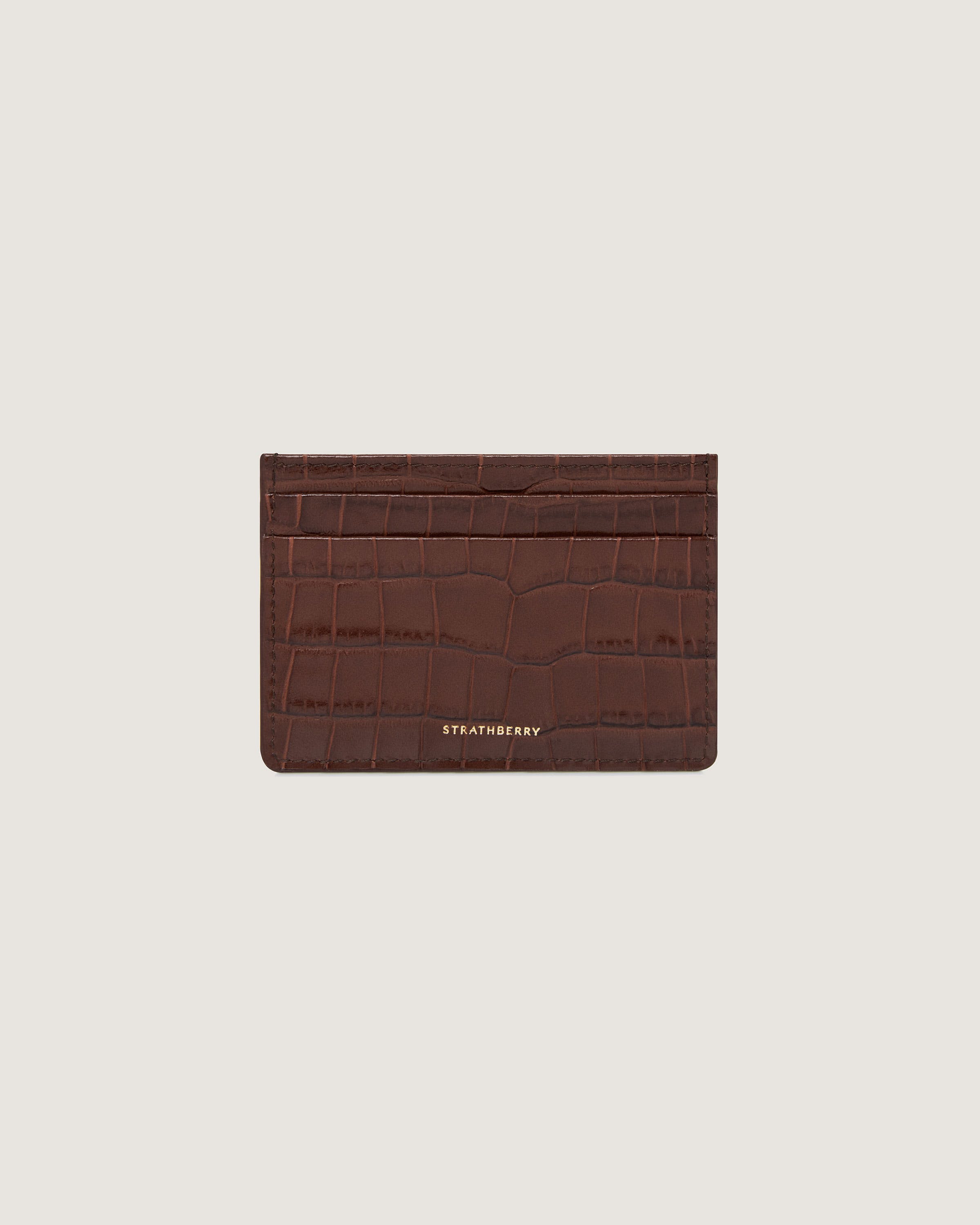 A brown card case with a crocodile pattern