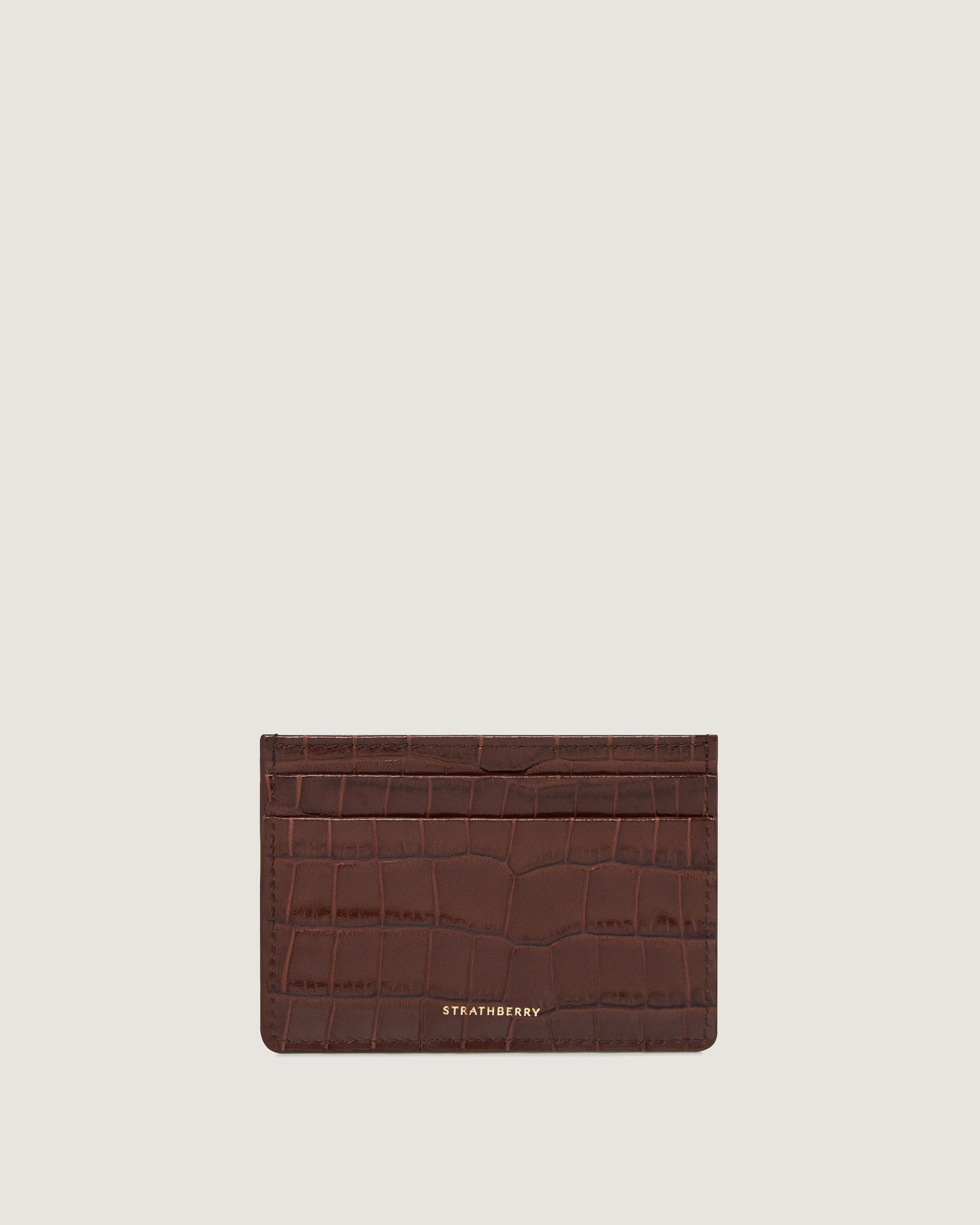 A brown card case with a logo on the front