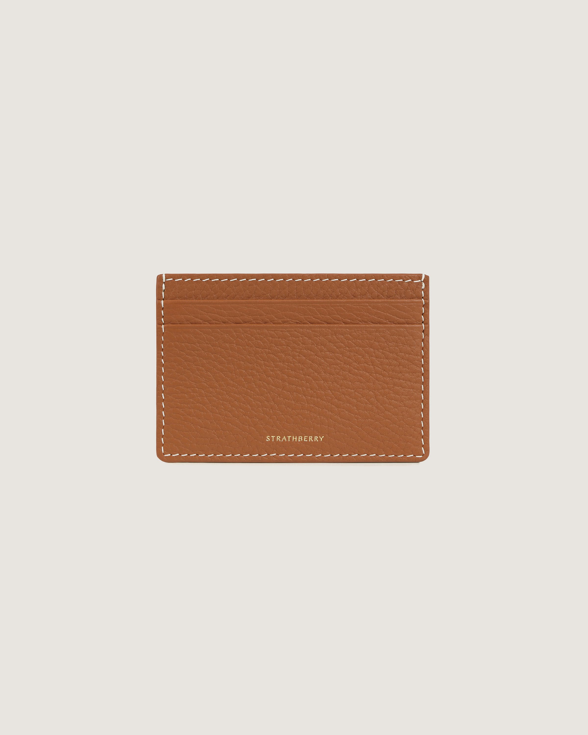 A tan leather card case on a white background