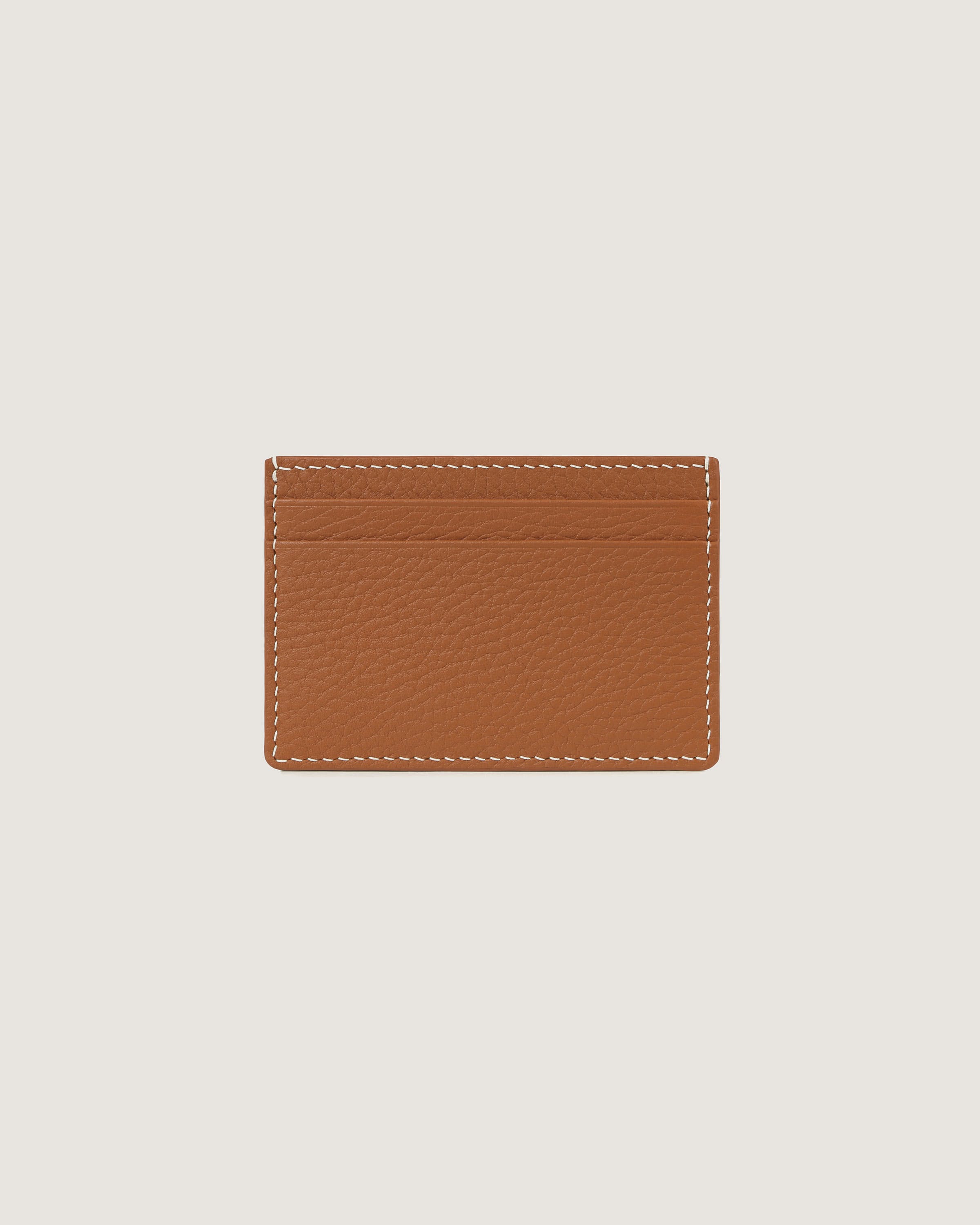 A tan leather card case with a white stitching