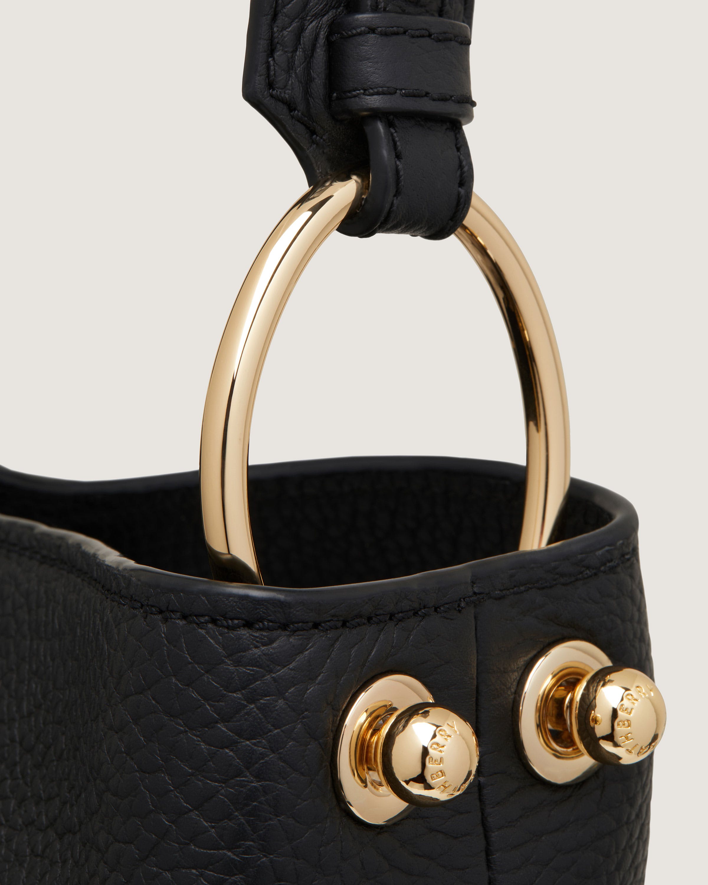 A black purse with a gold handle