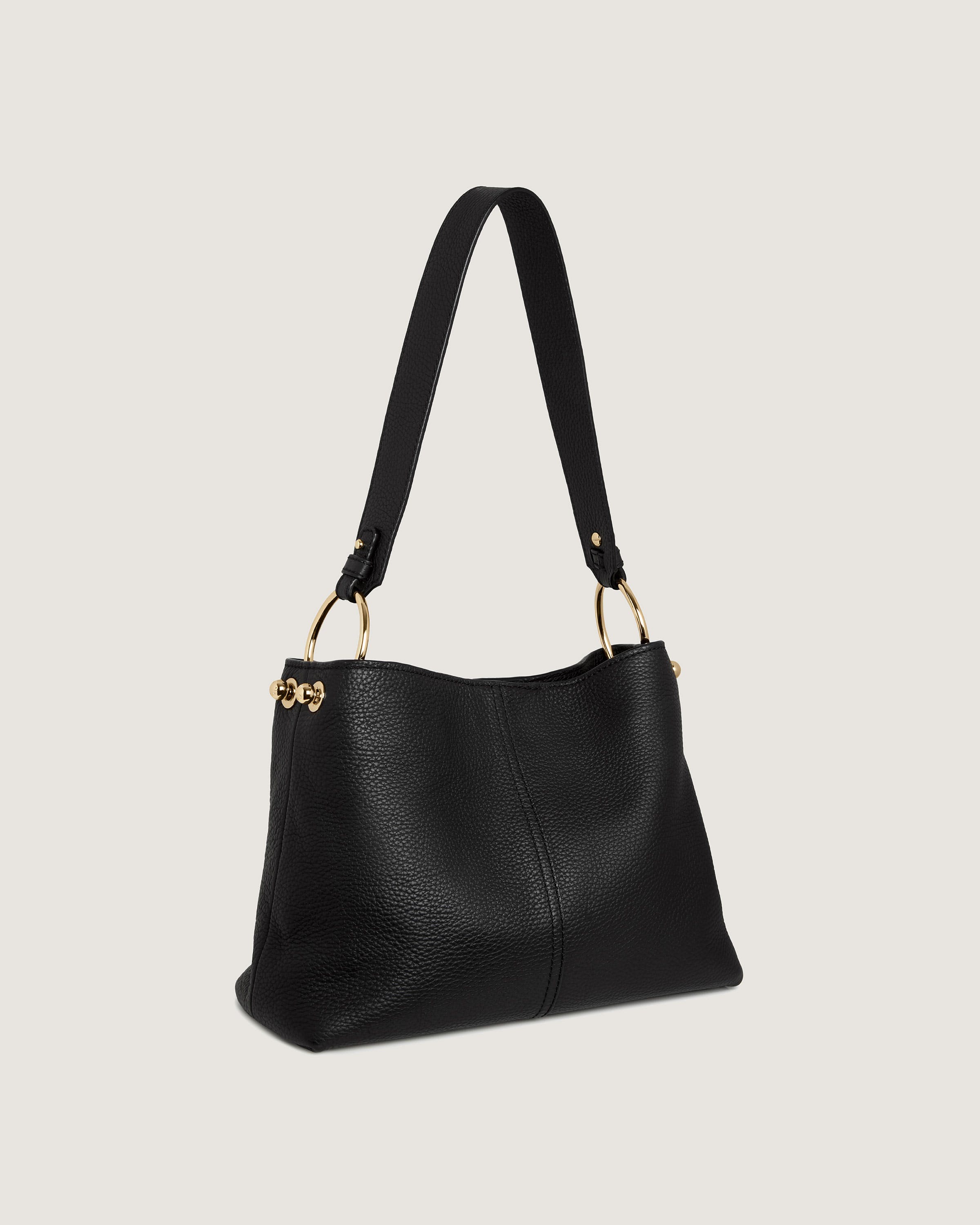 A black handbag with a gold handle