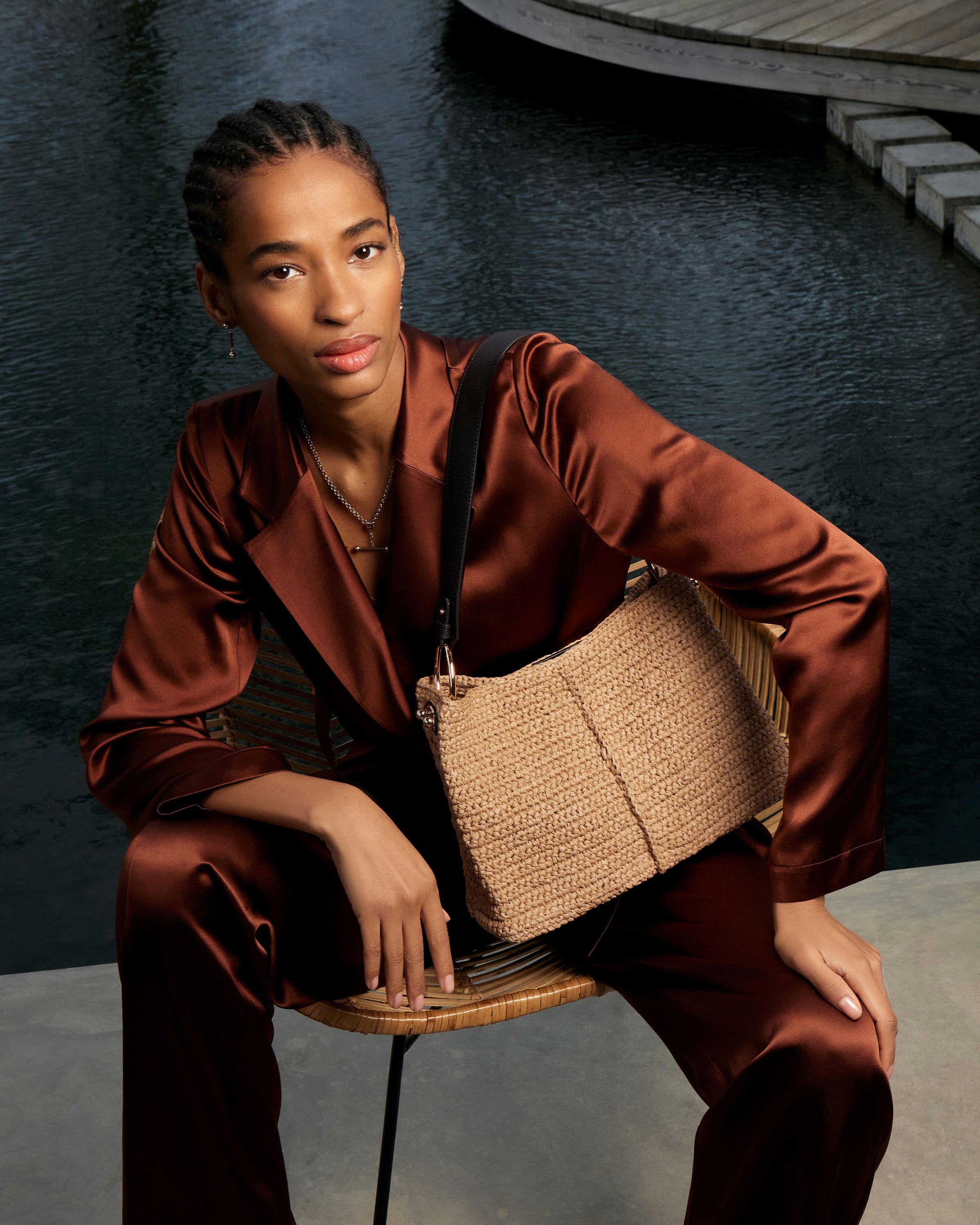 A woman sitting on a chair holding a purse