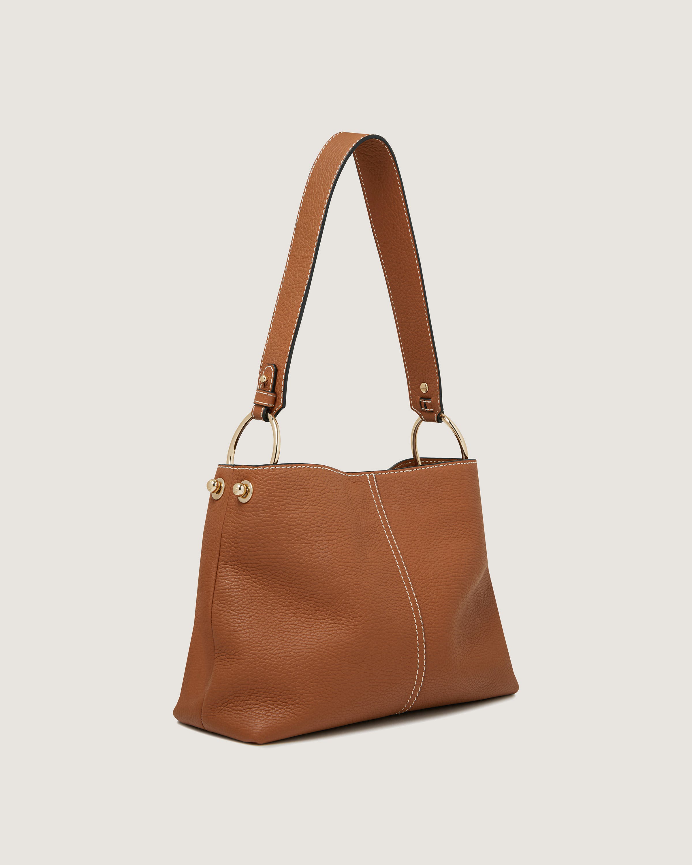 A brown leather handbag on a white background