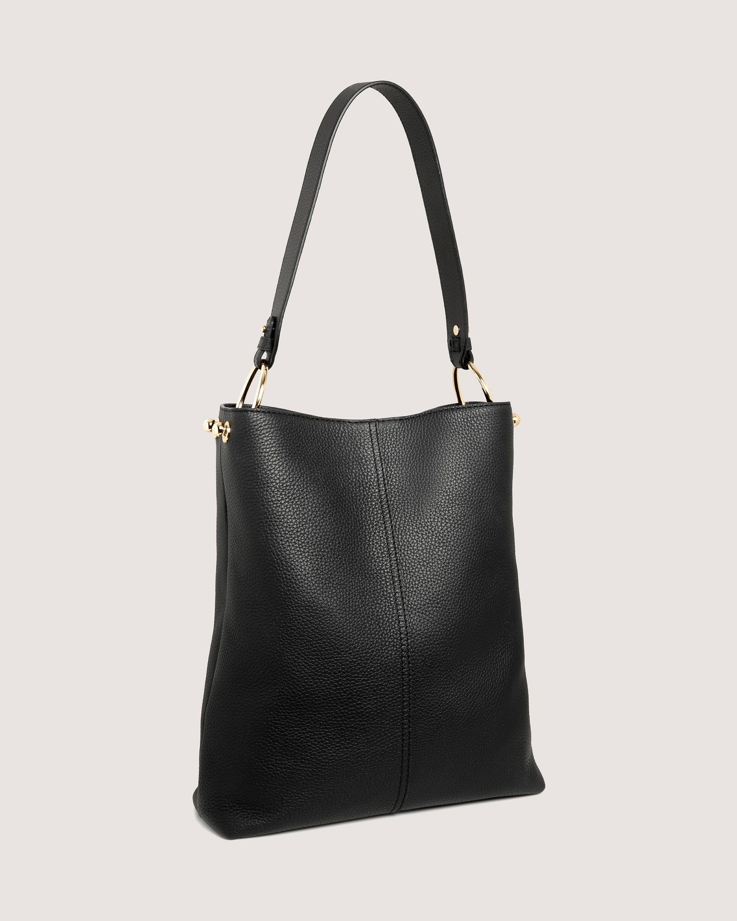 A black leather handbag with a gold handle