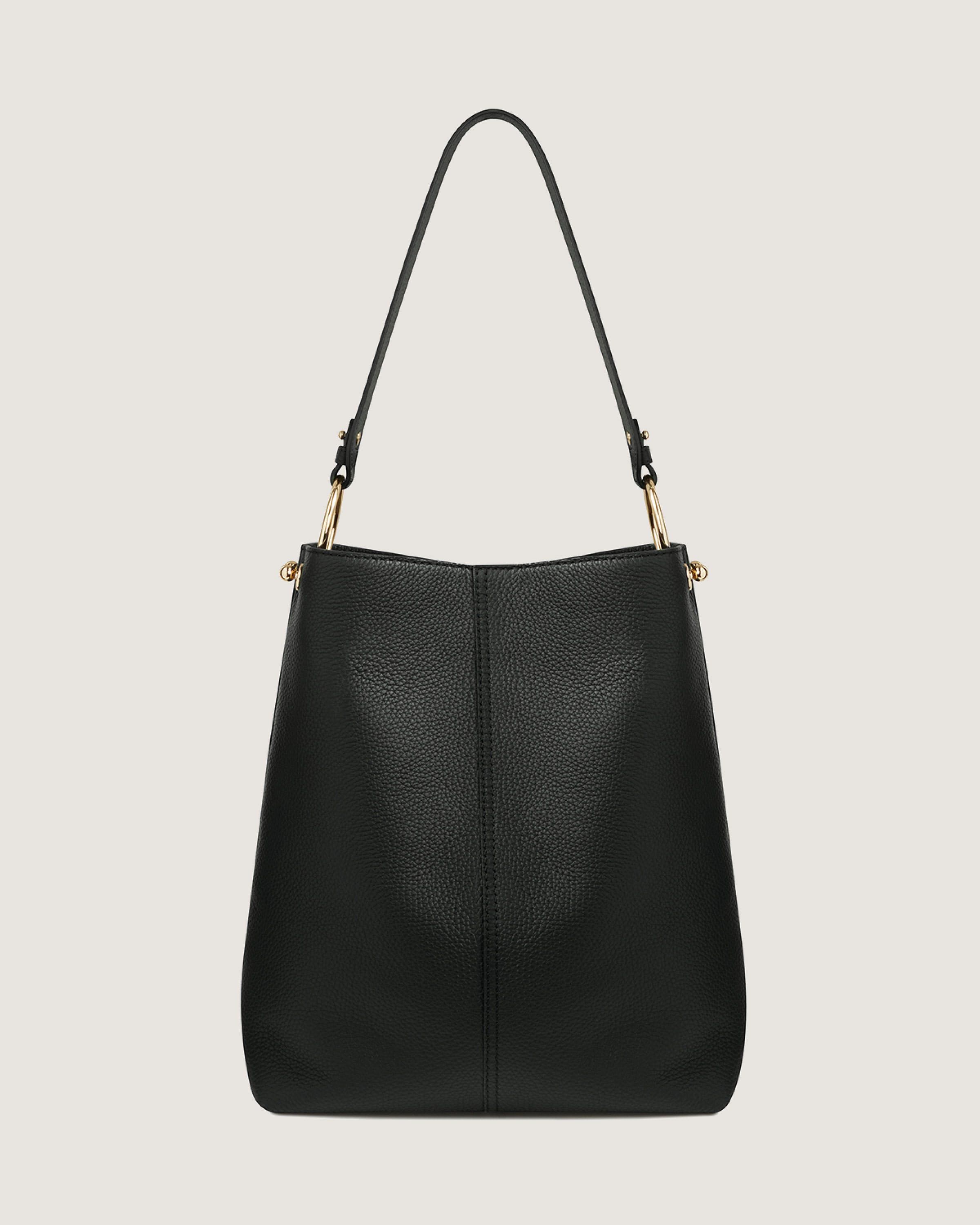 A black leather handbag with gold handles