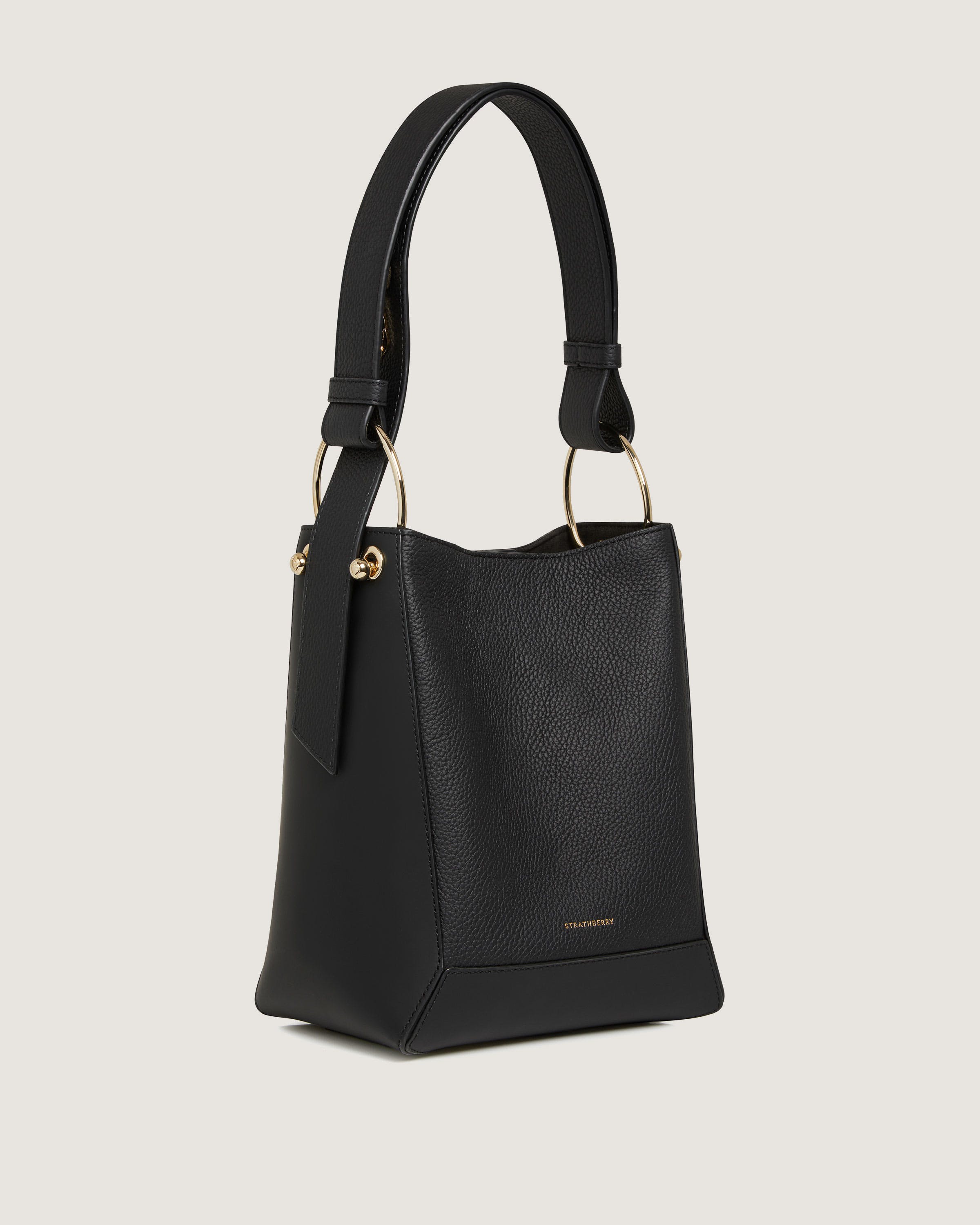 A black handbag with a gold handle