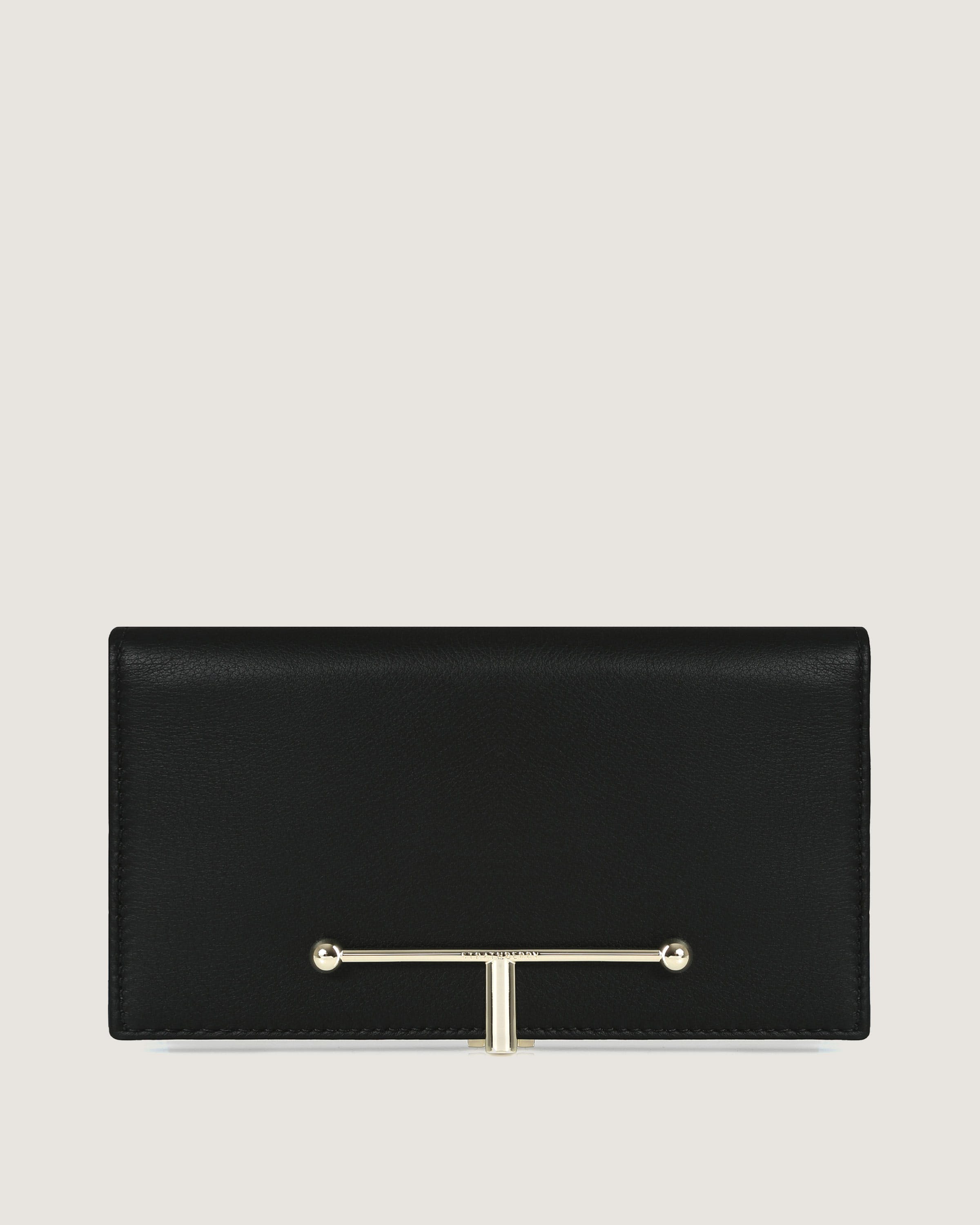 A black leather purse with a metal bar on the front