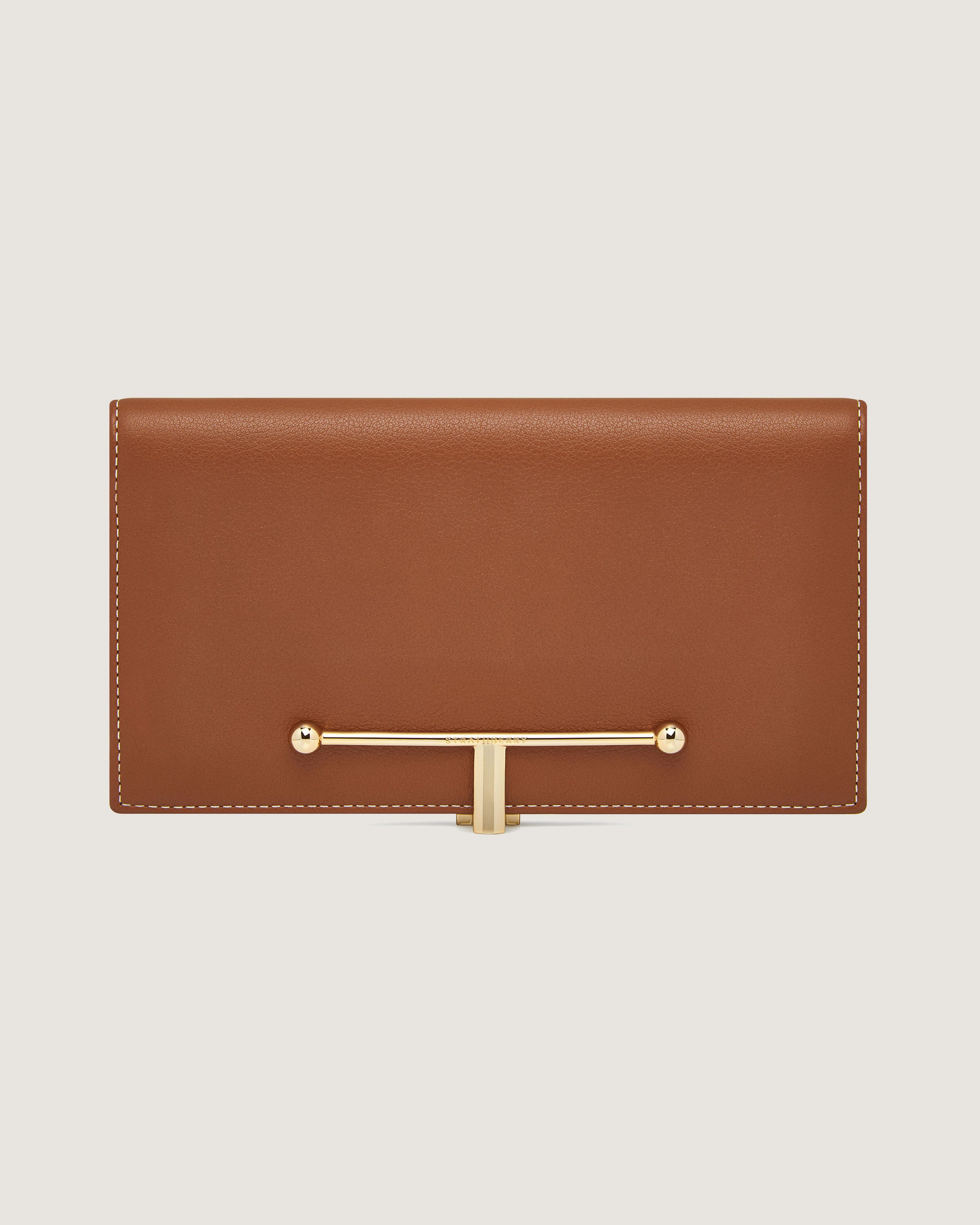 A brown leather wallet with a gold handle