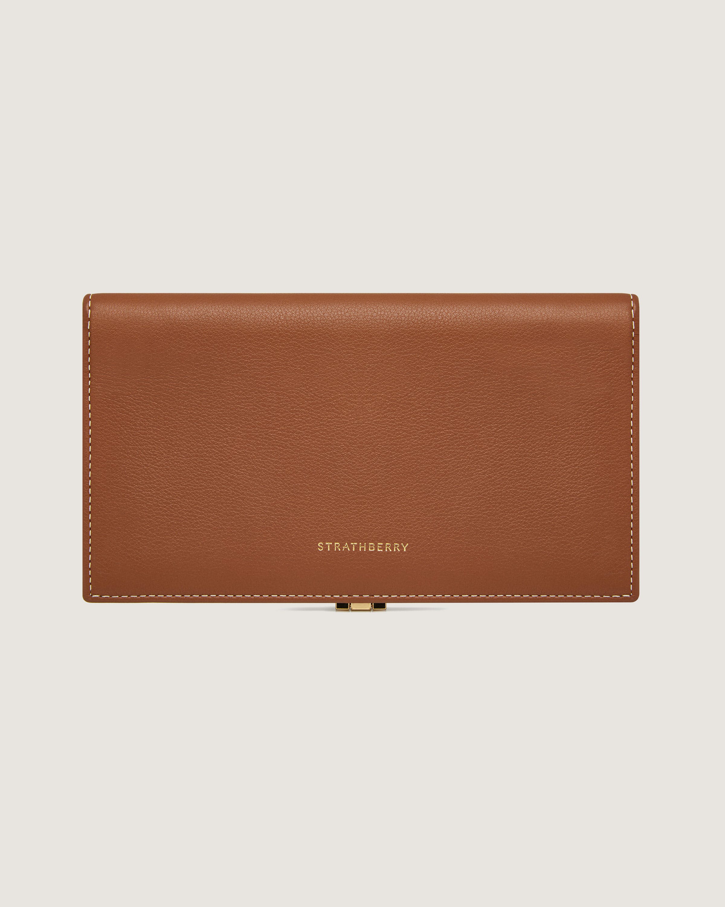 A tan leather wallet on a white background