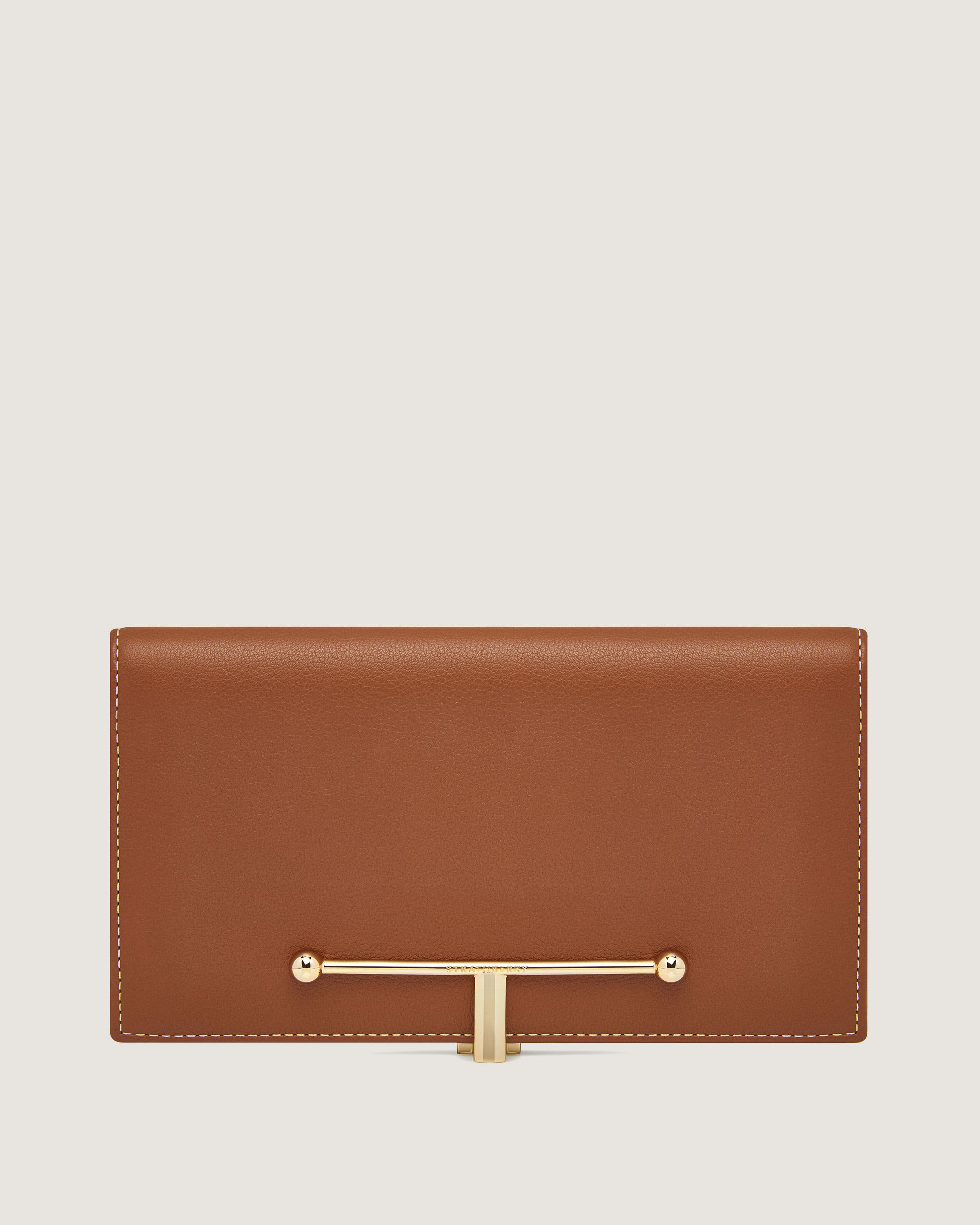 A brown leather wallet with a gold bar on the front