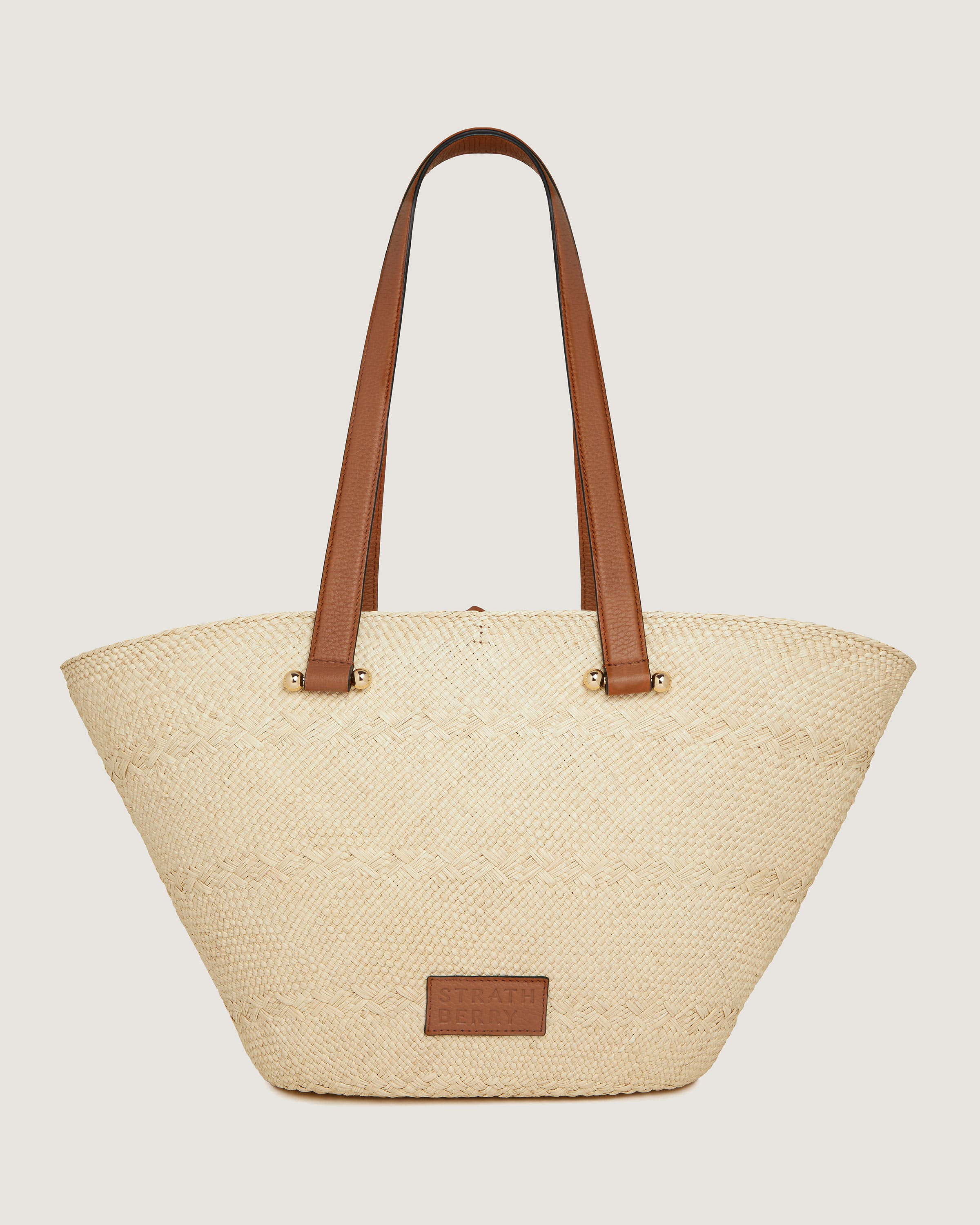 A white and brown bag with a brown handle