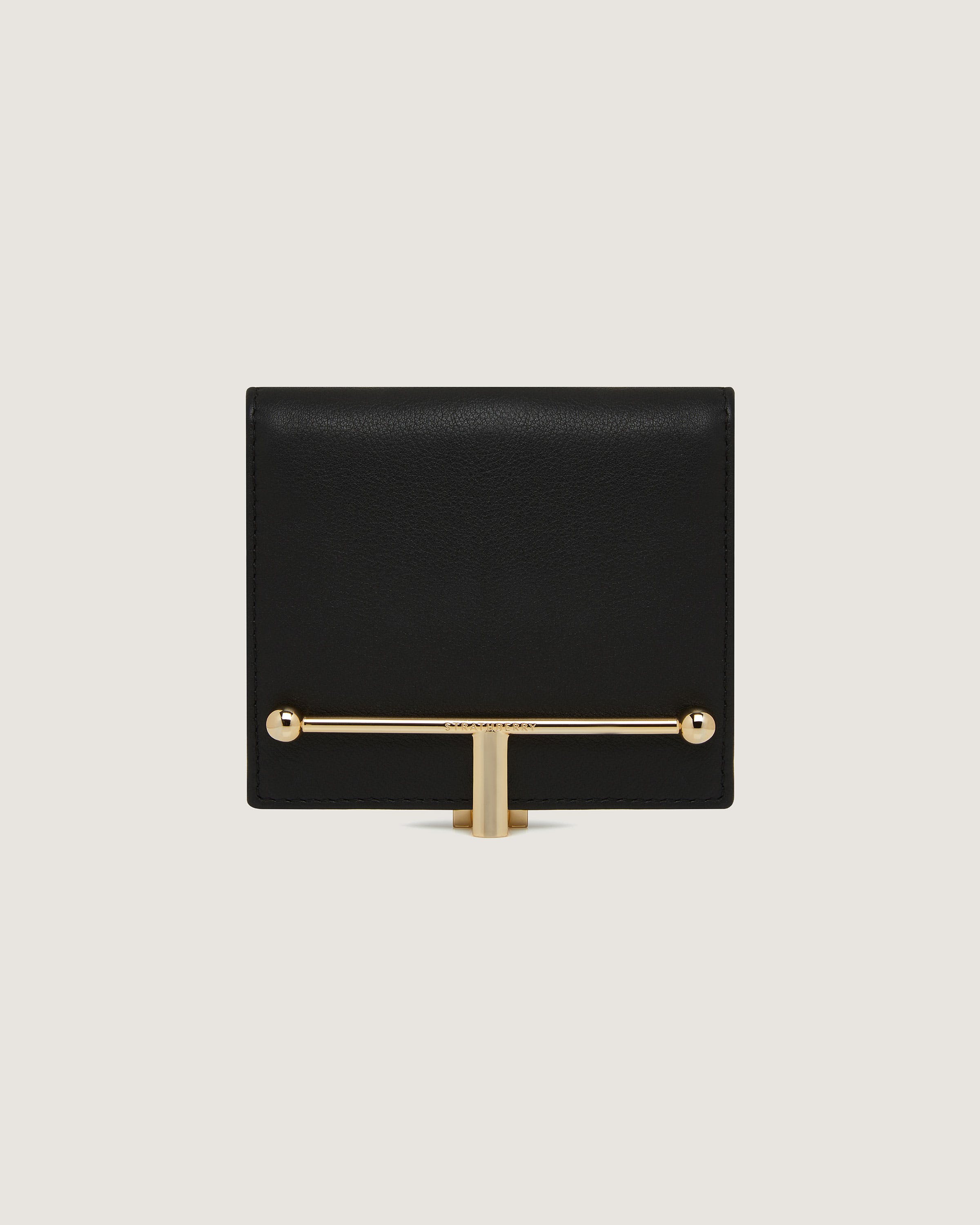 A black and gold clutch bag with a gold handle