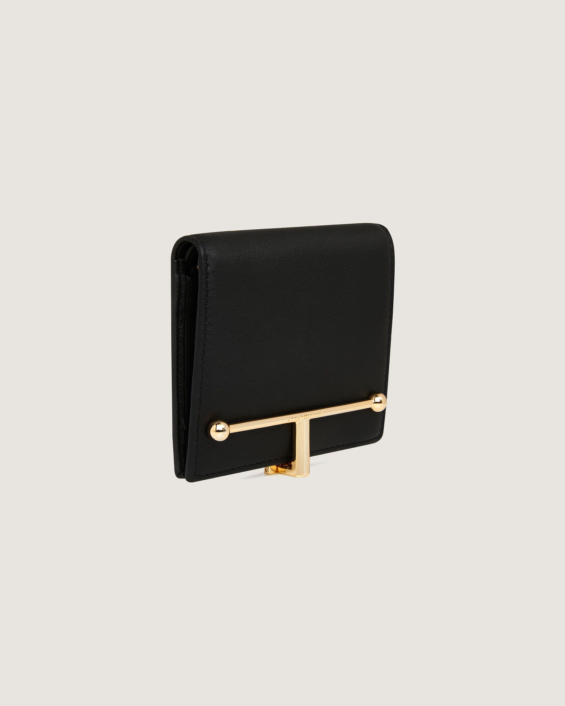 A black purse with a gold handle