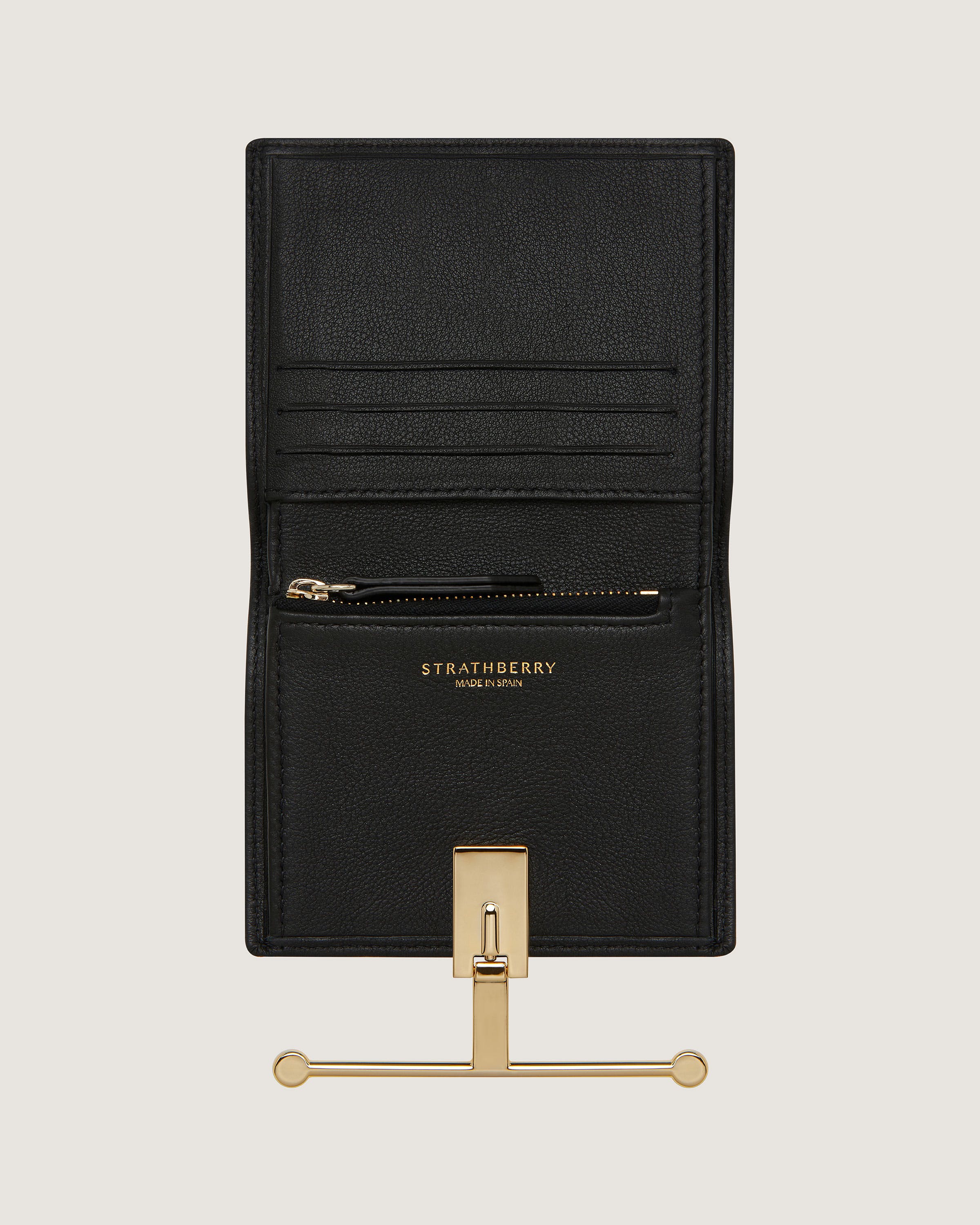 A black leather wallet with a gold metal hook