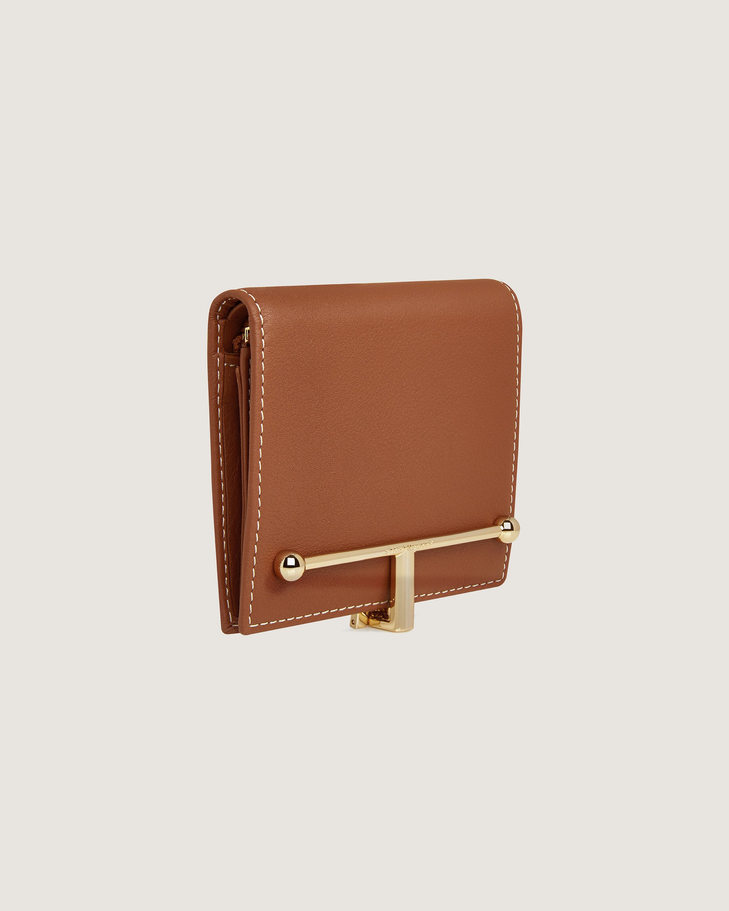 A brown leather wallet with a gold handle