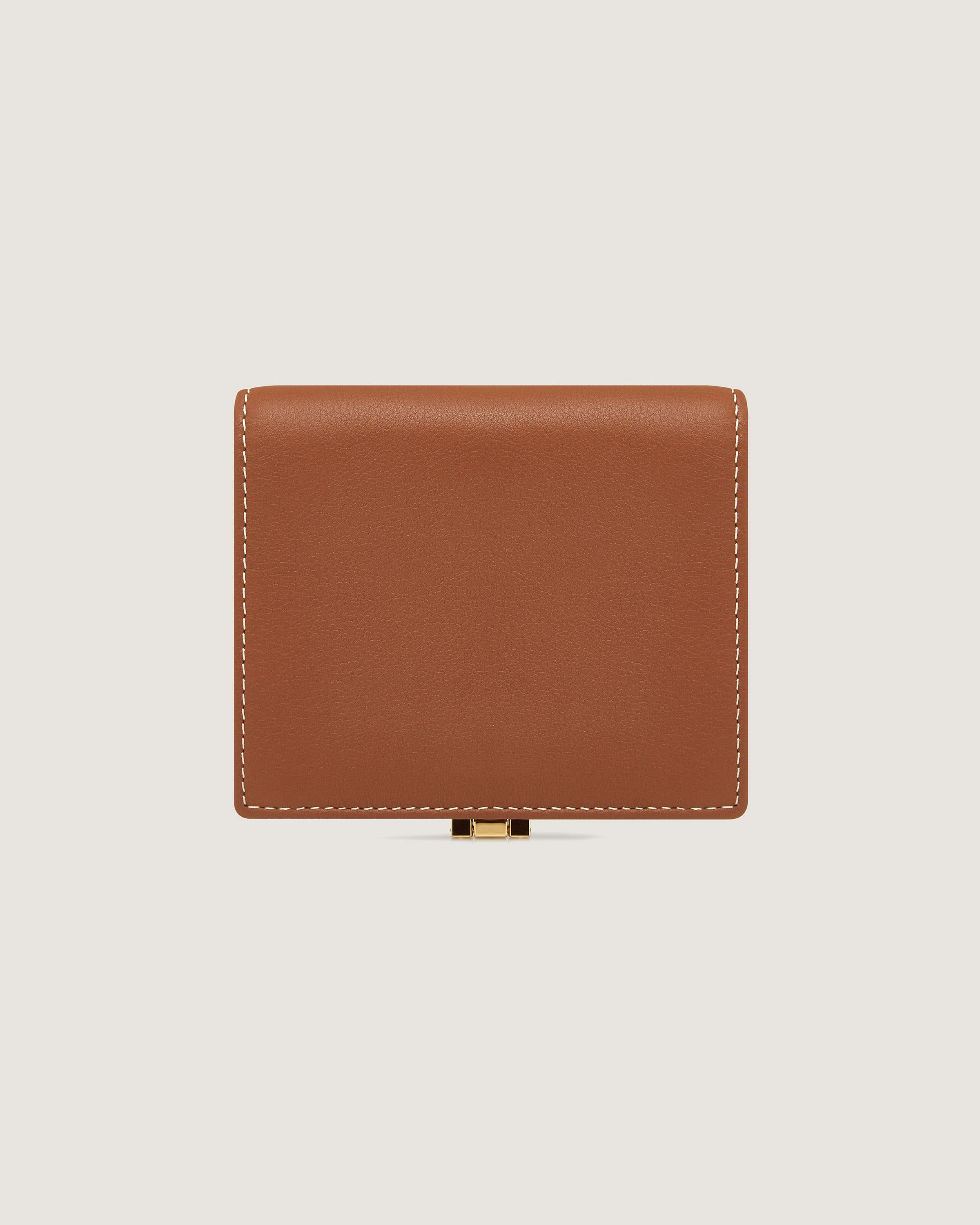 A brown leather wallet with a gold clasp