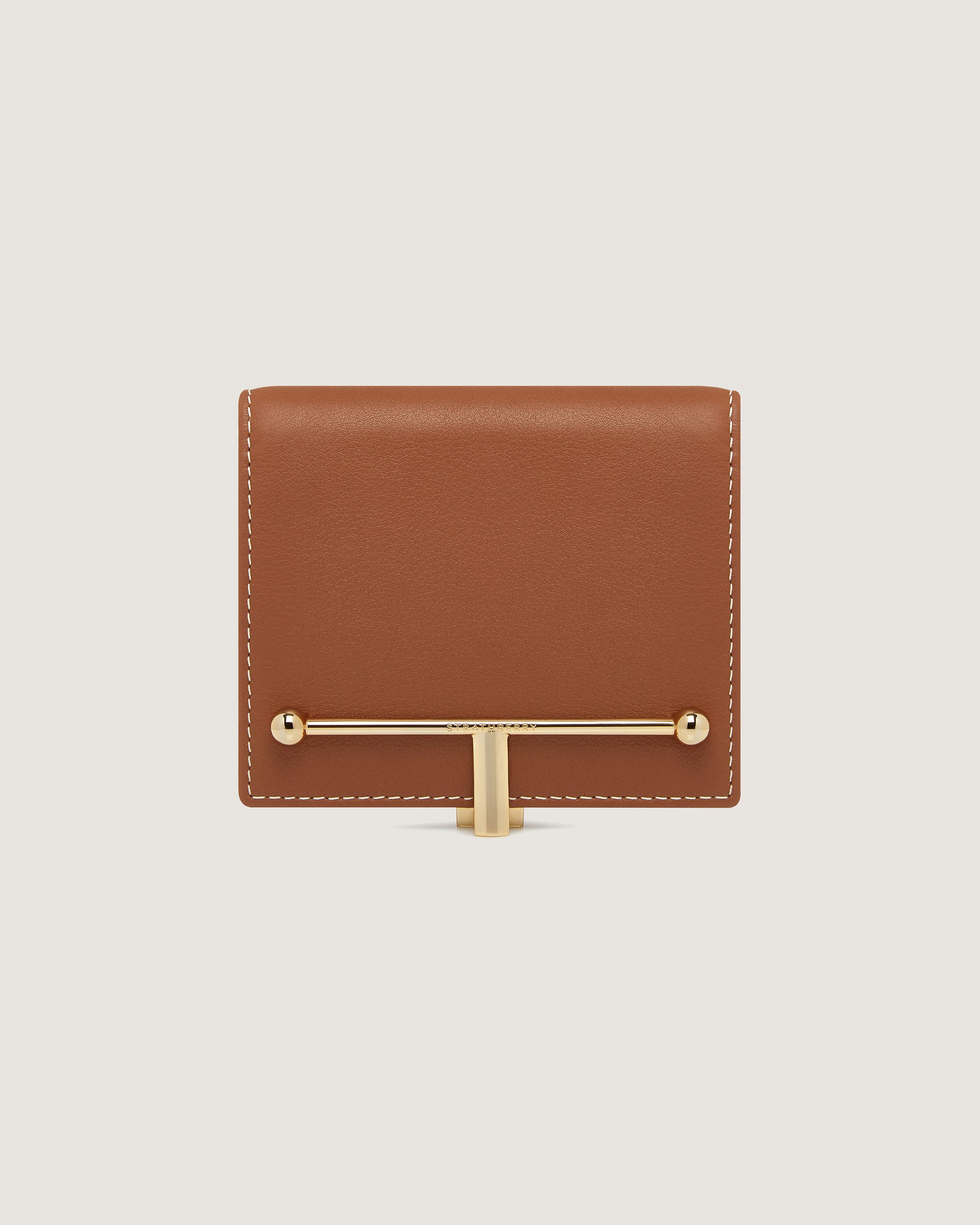 A brown leather wallet with a gold handle