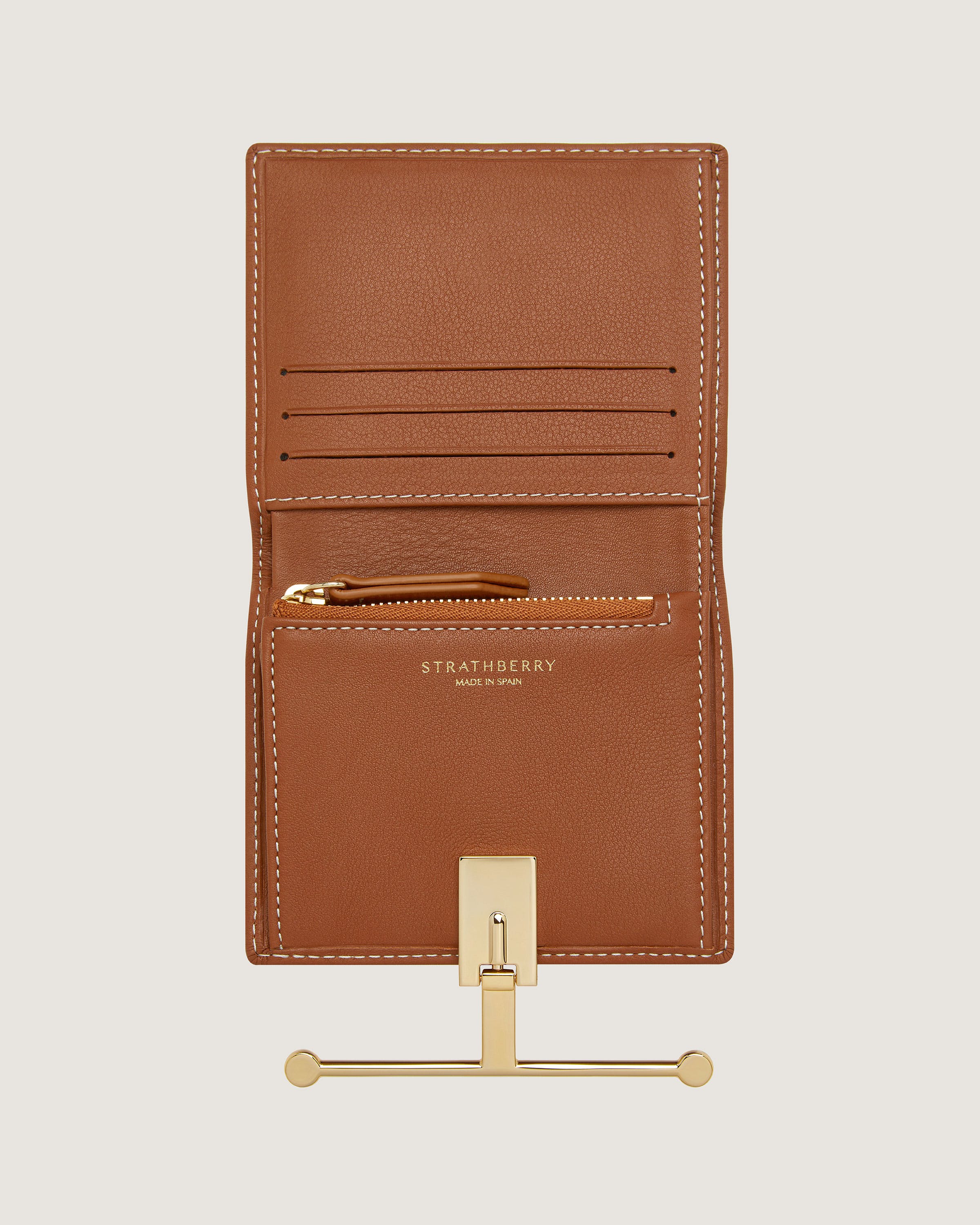 A brown leather wallet with a gold metal holder