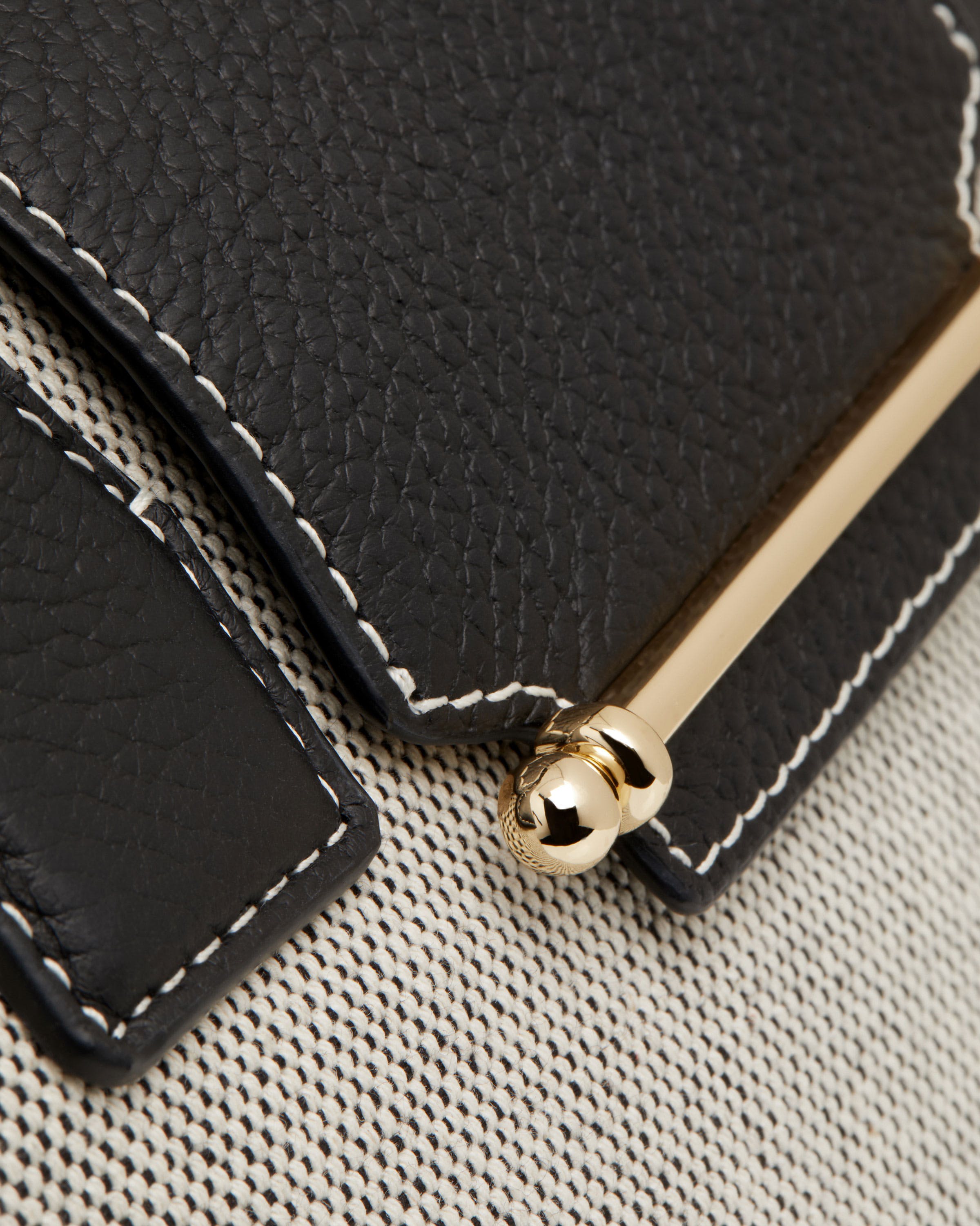 A close up of a black and white purse