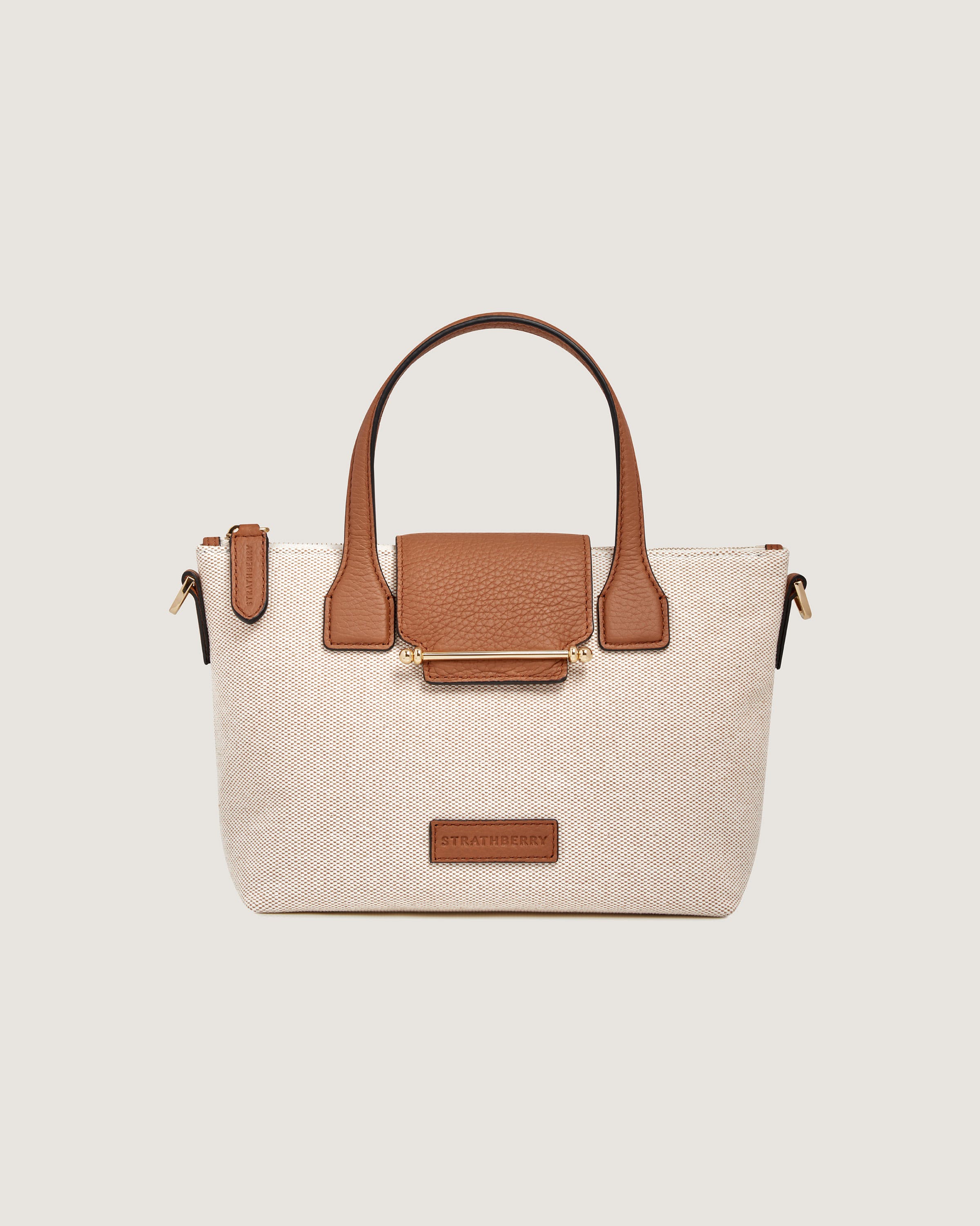 A white and brown handbag with a brown handle