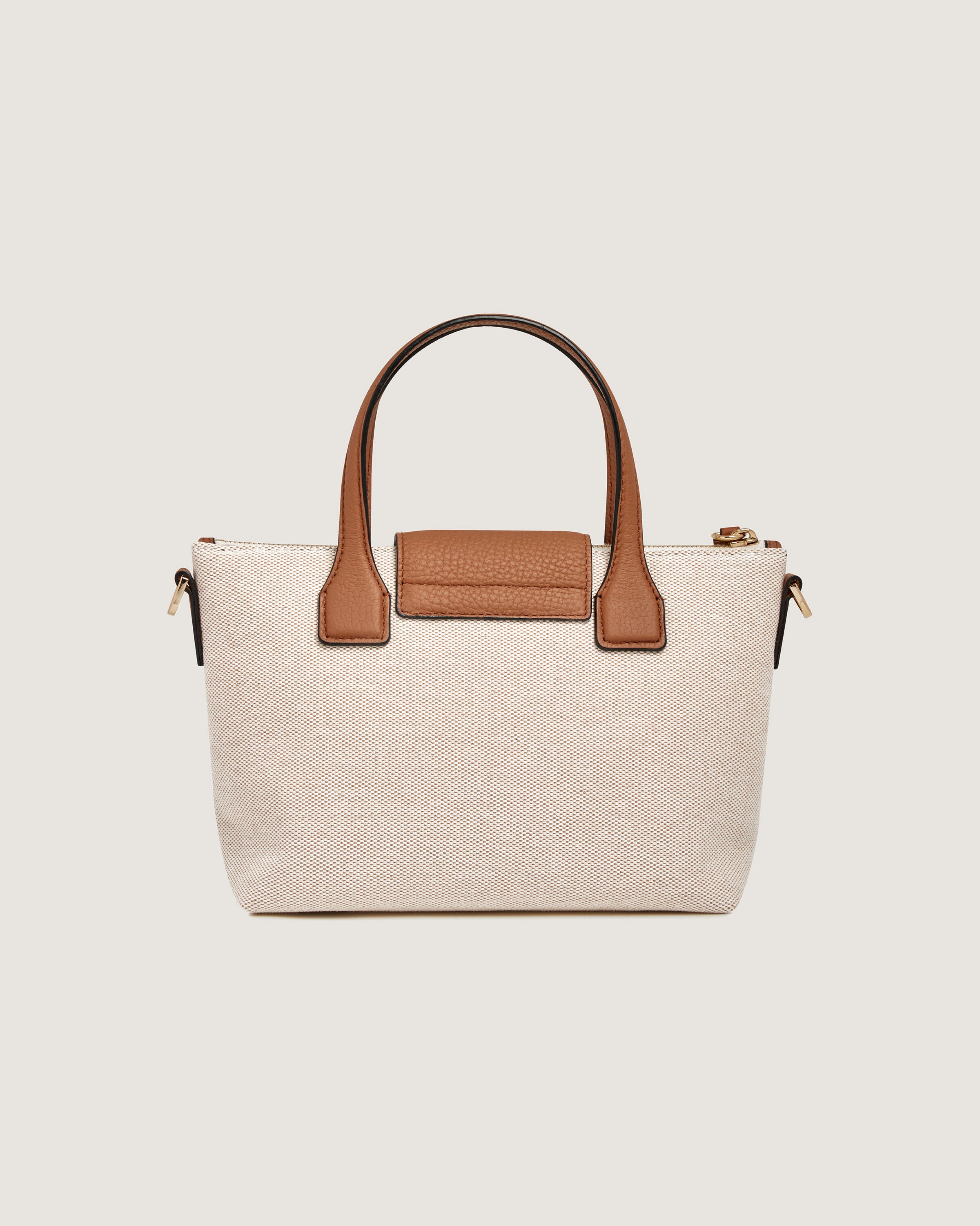 A white and brown handbag with a brown handle