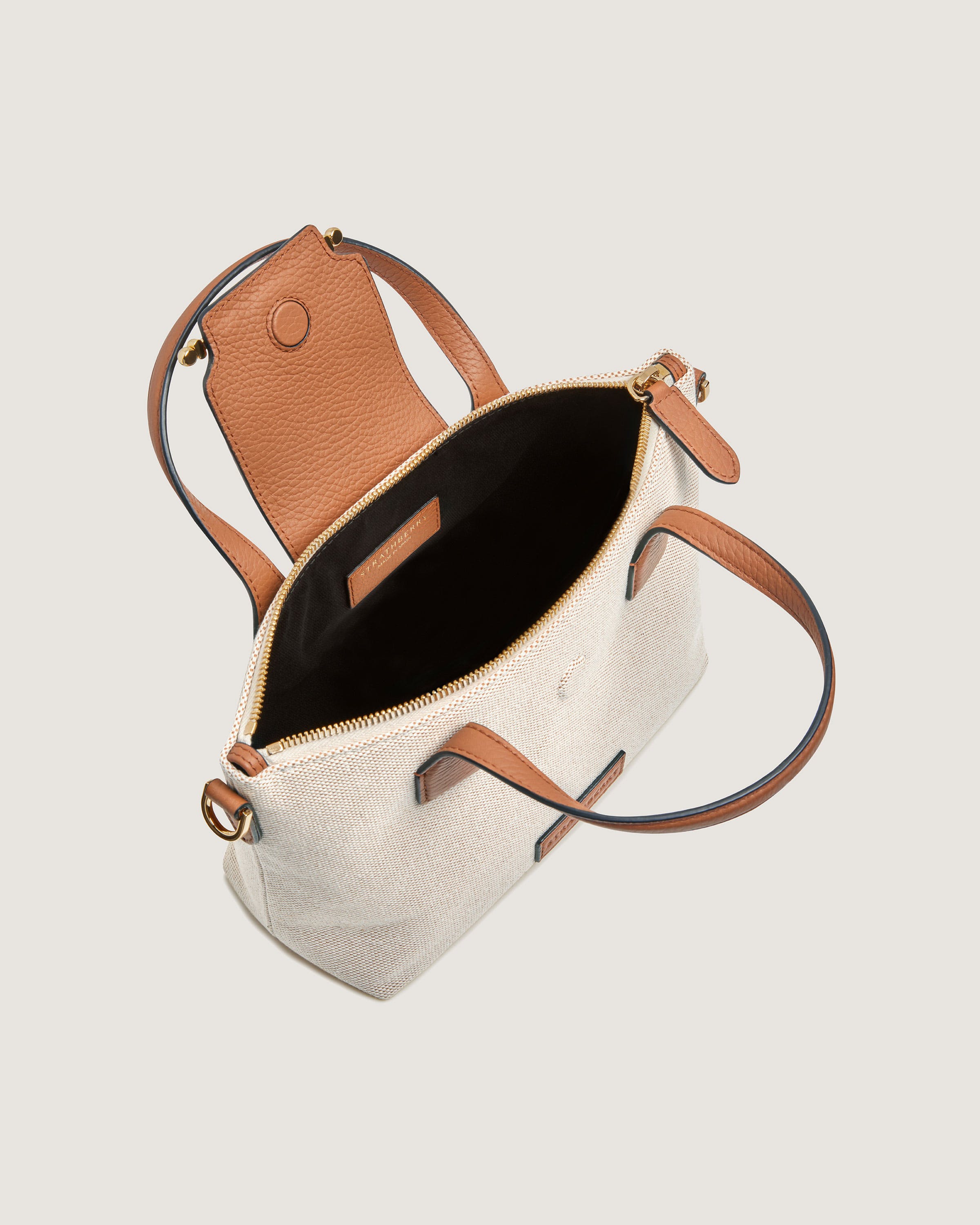 A white purse with a brown strap