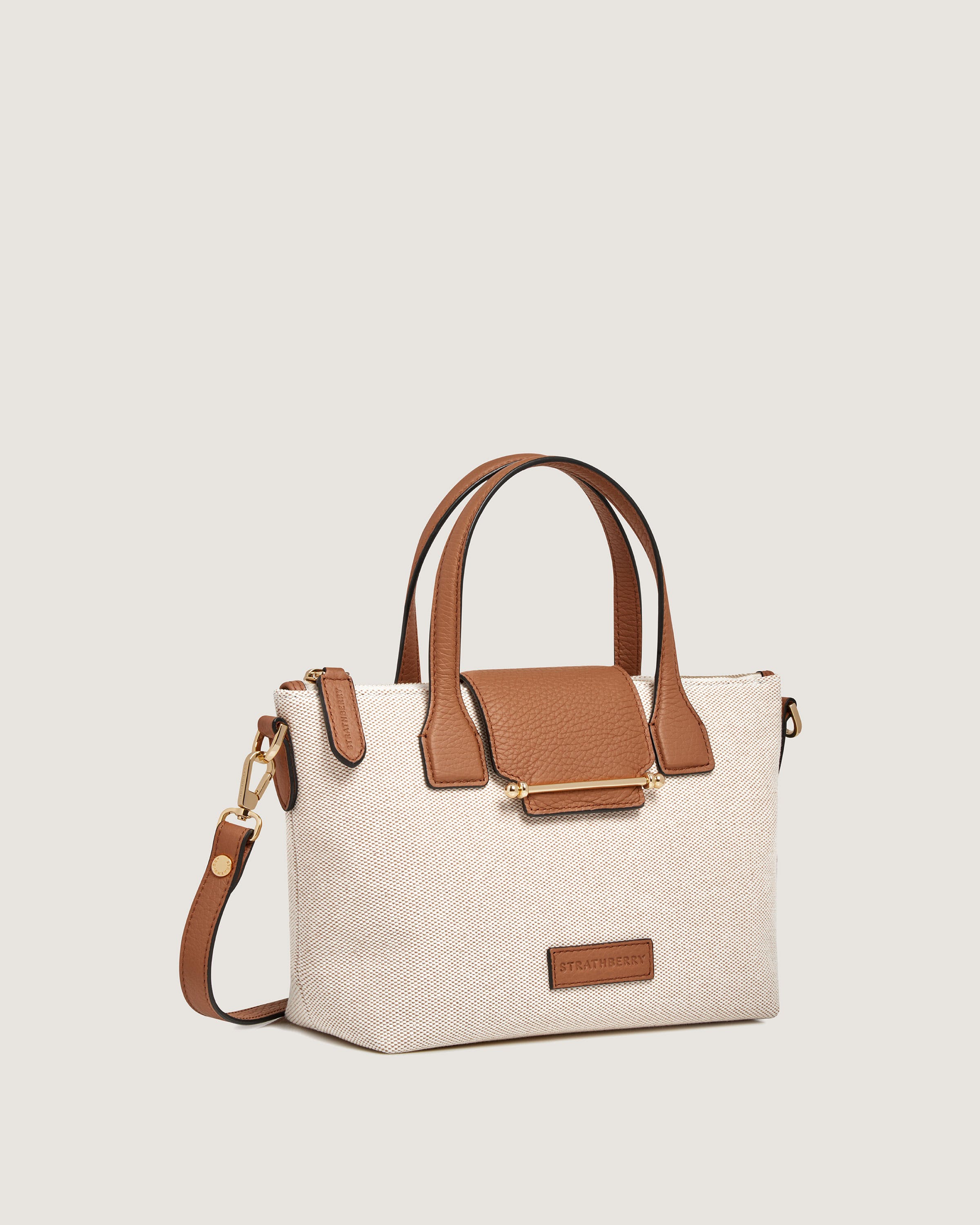 A white and brown handbag on a white background