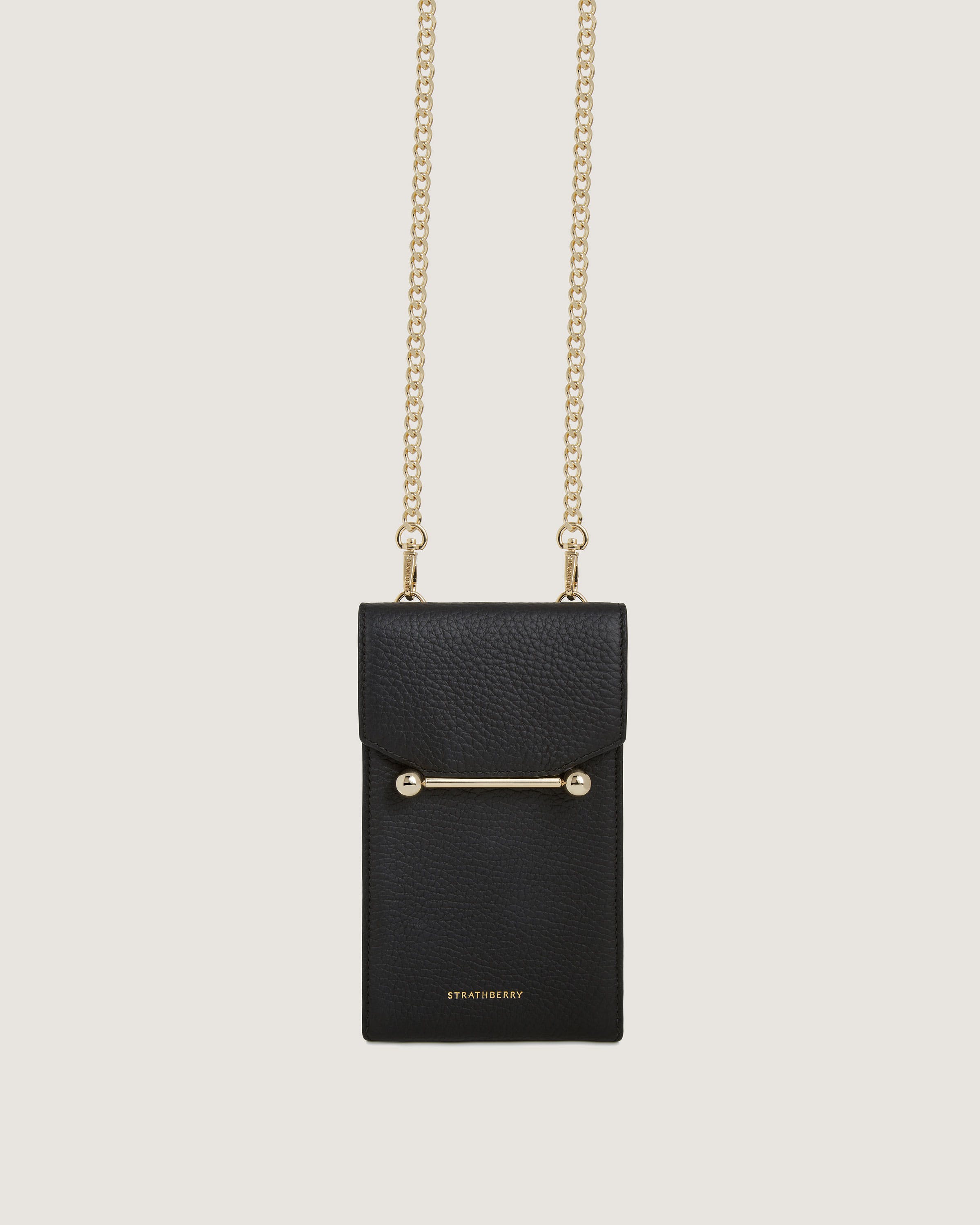 A black bag with a gold chain hanging from it