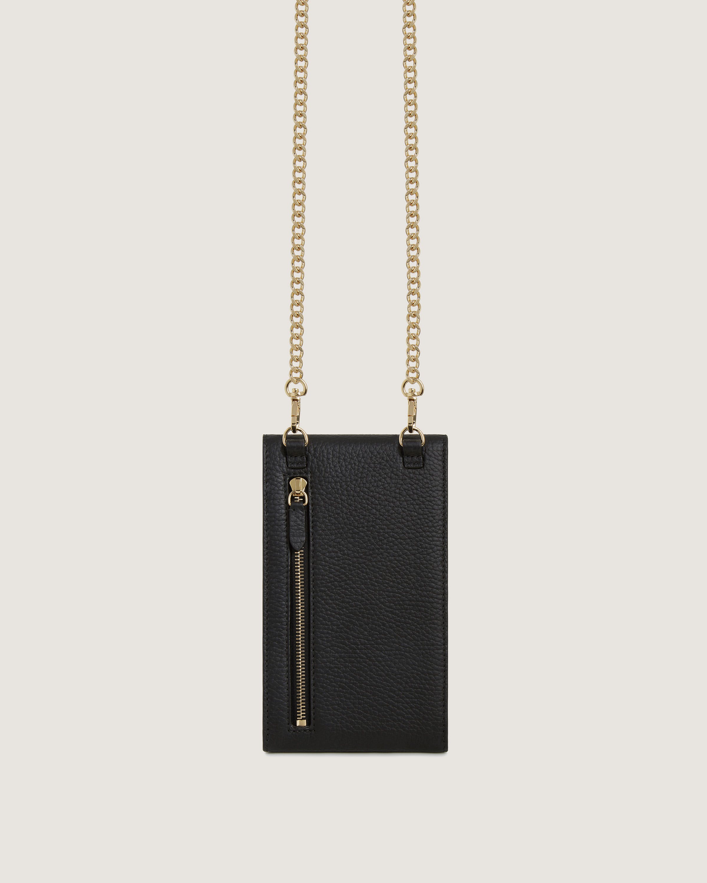 A black bag with a gold chain hanging from it