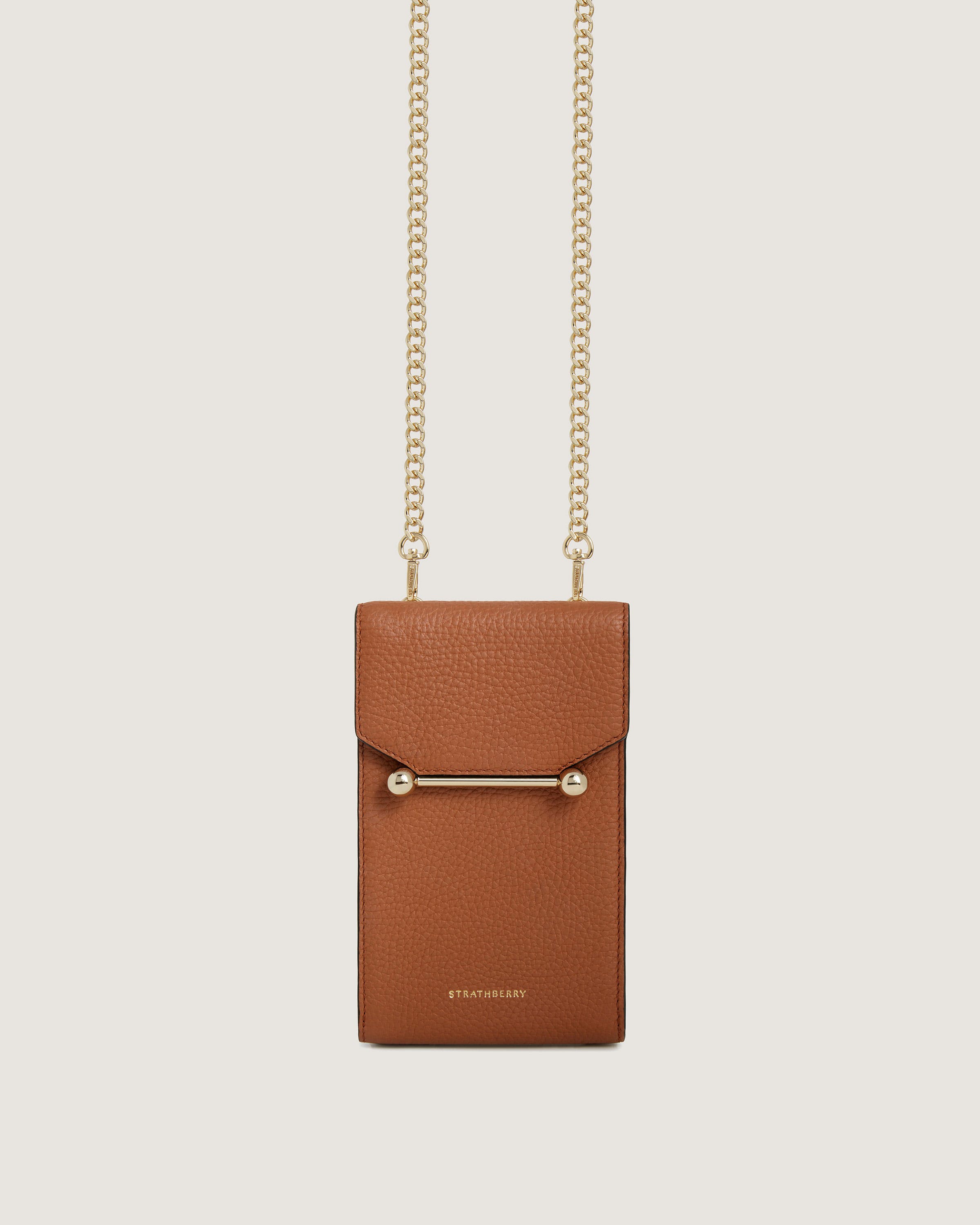 A small brown bag with a chain hanging from it