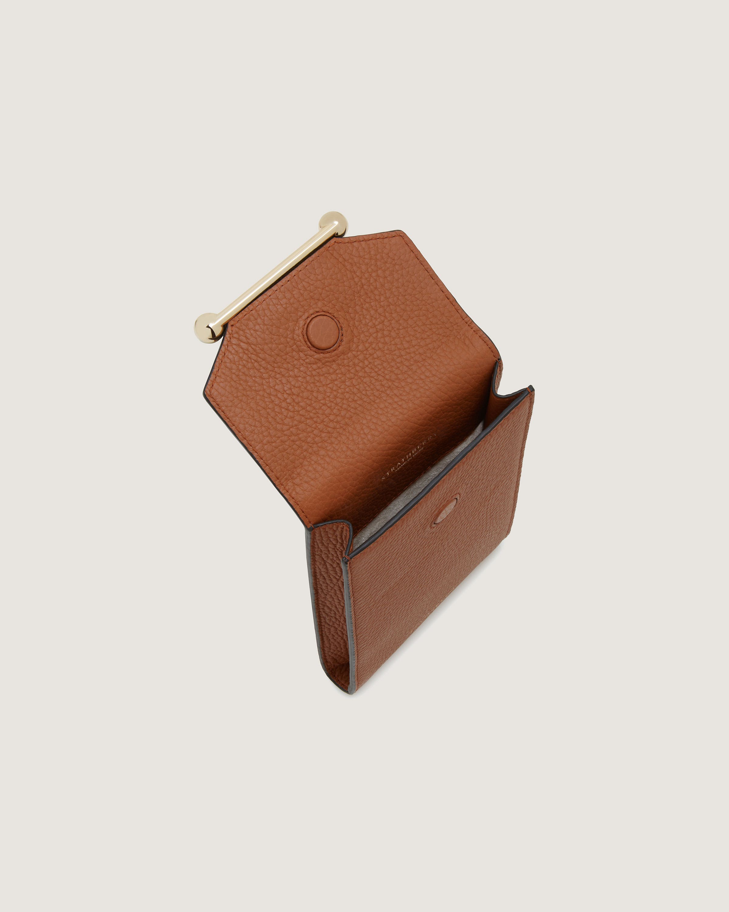 A brown leather wallet with a gold clasp