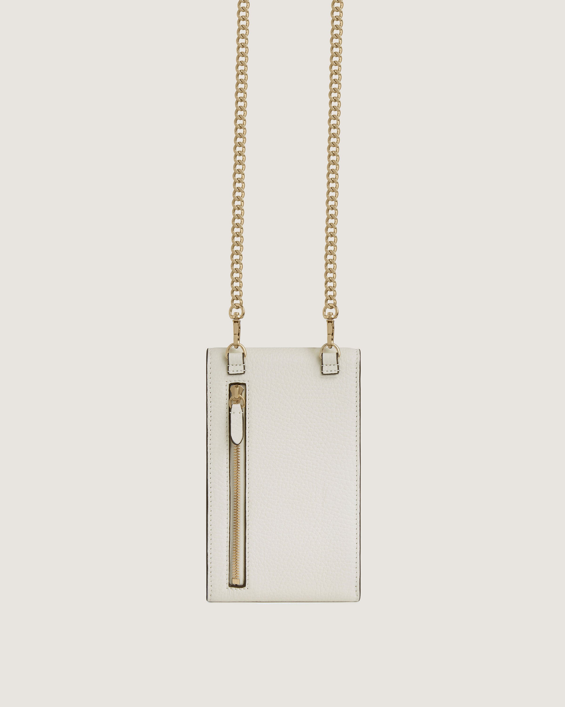 A white bag with a gold chain hanging from it