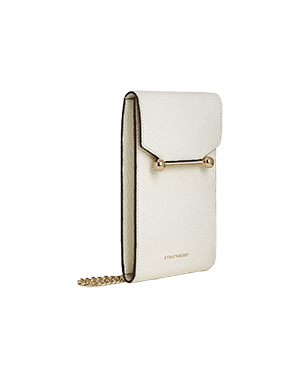 A white purse with a chain hanging from it