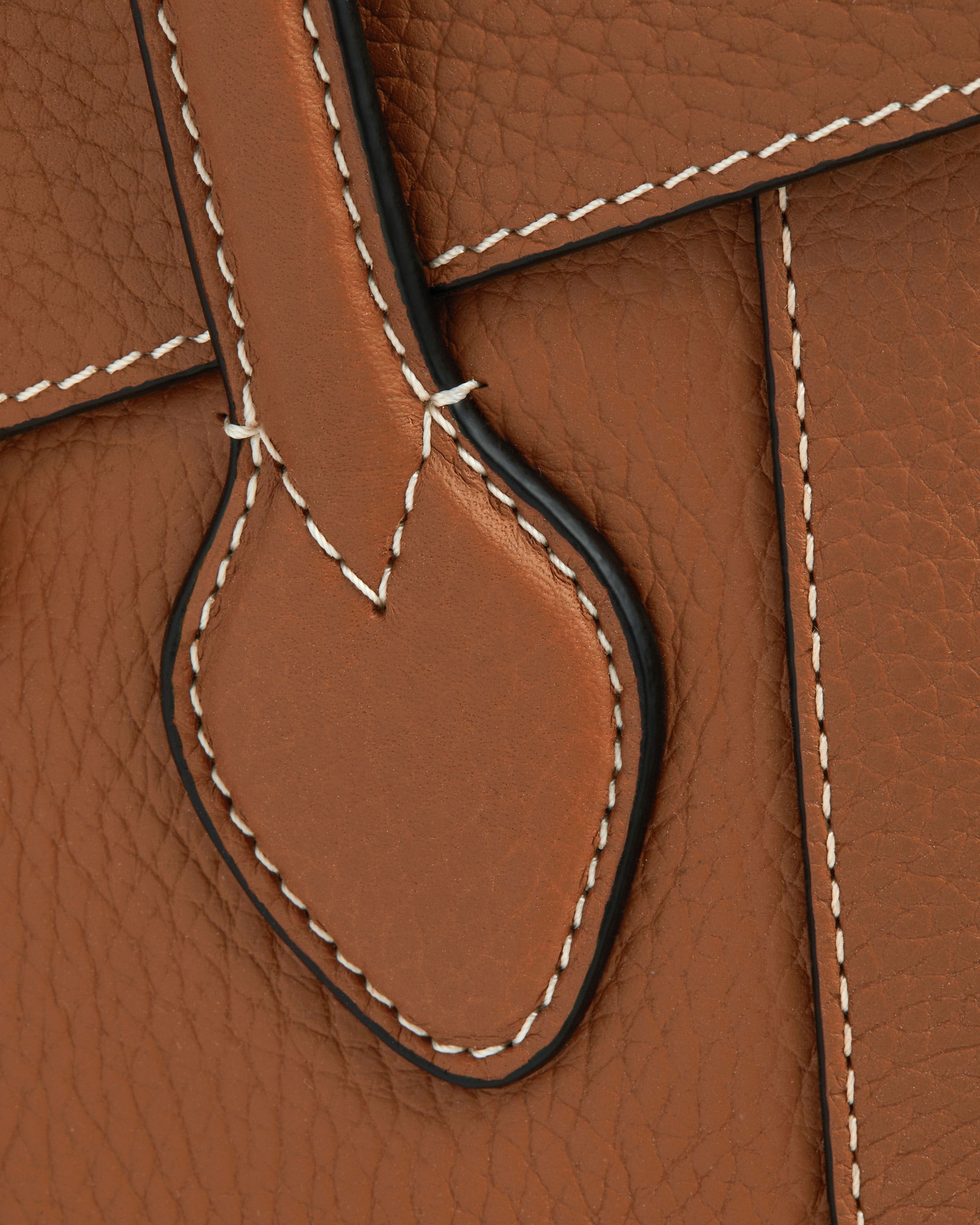 A close up of a brown leather bag