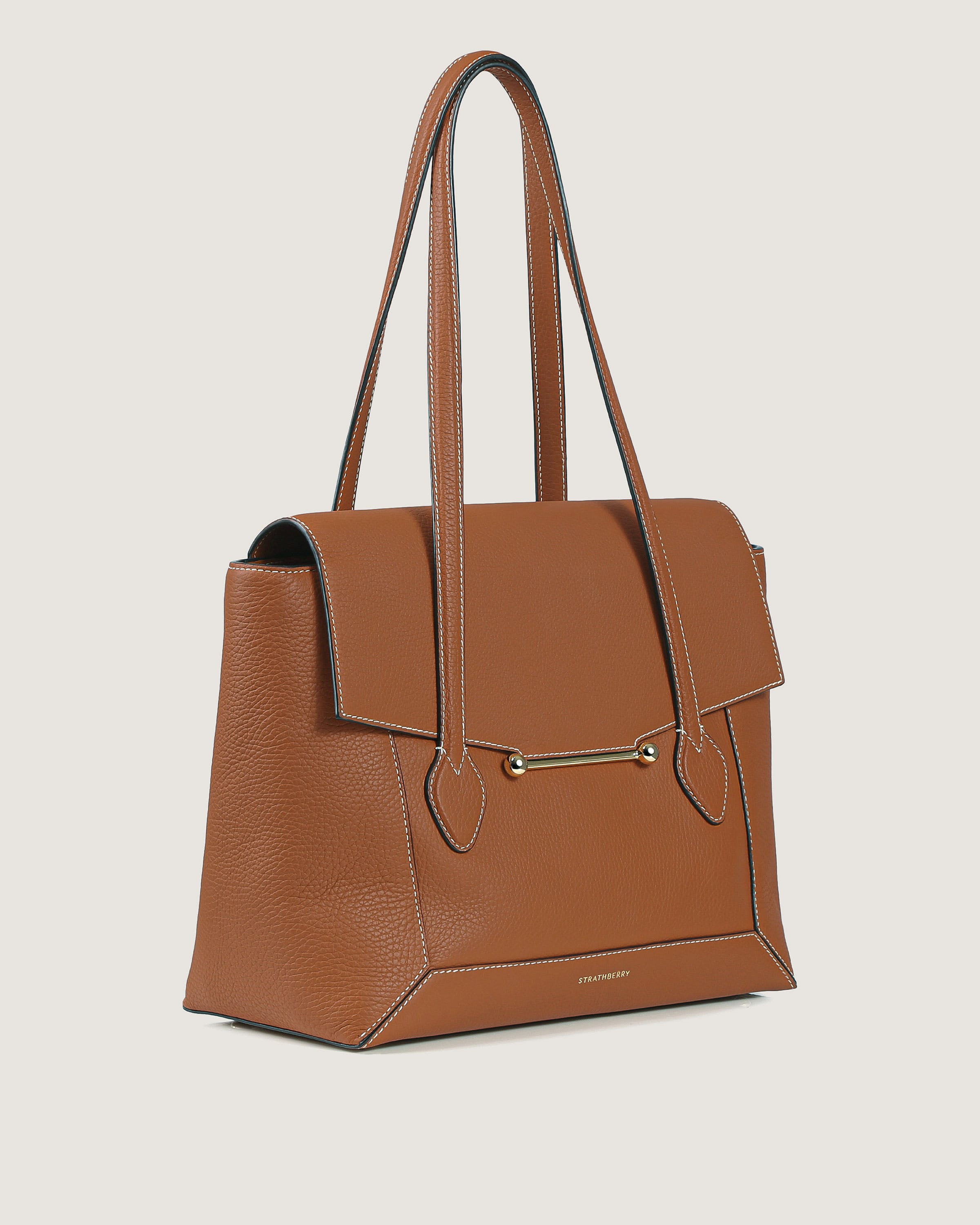 A brown handbag with a zipper on the side