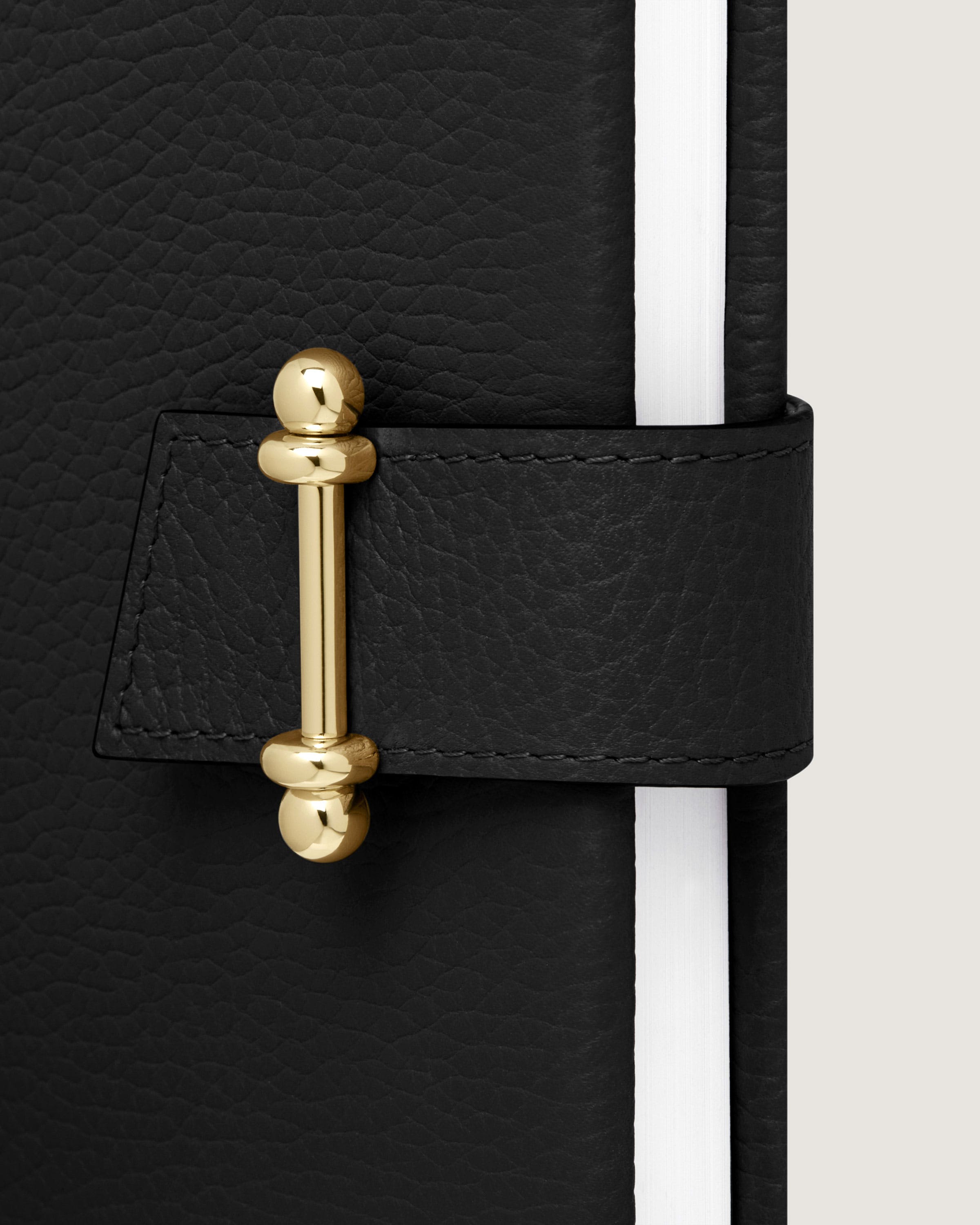 A black and white book with a gold handle