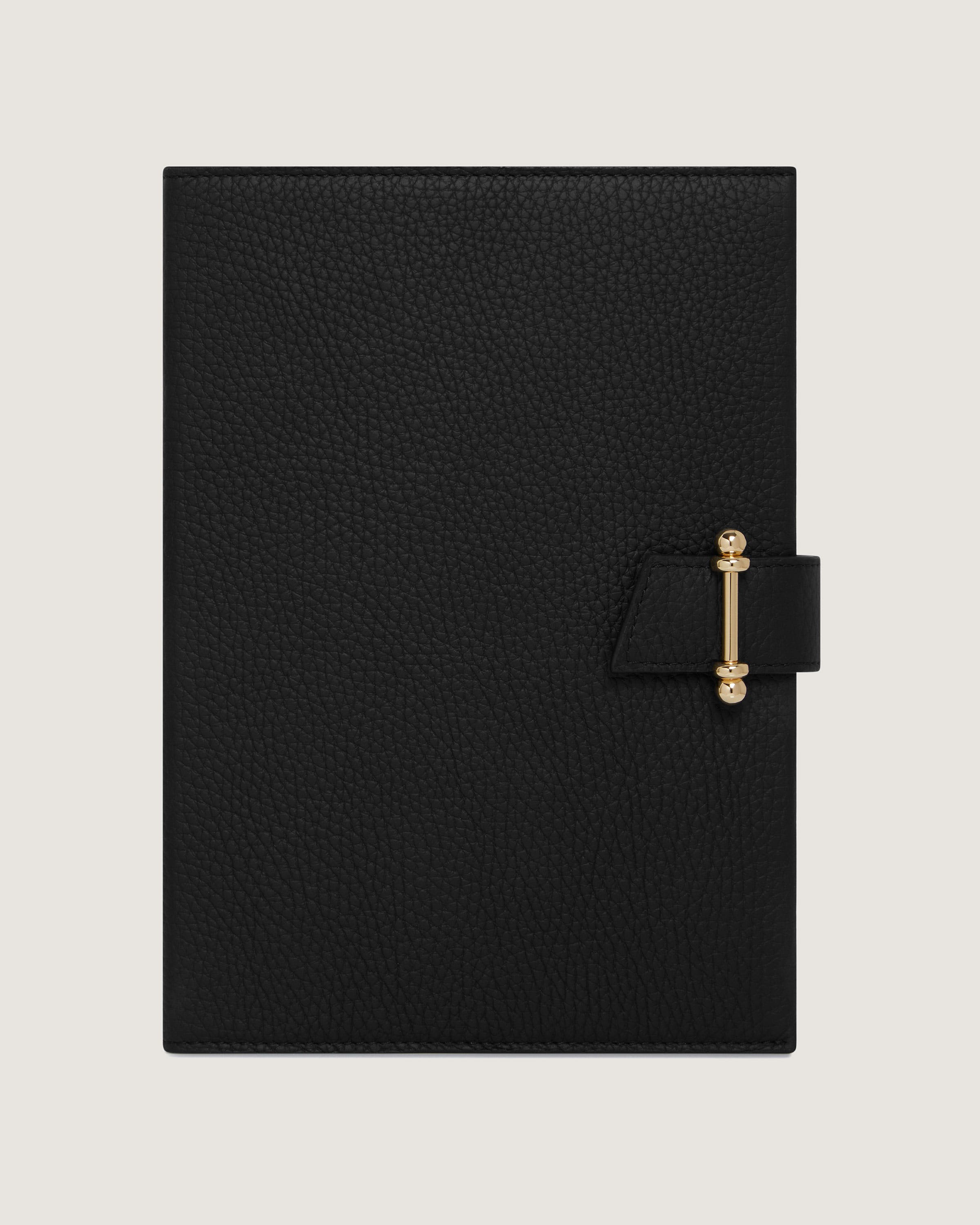 A black notebook with a gold handle