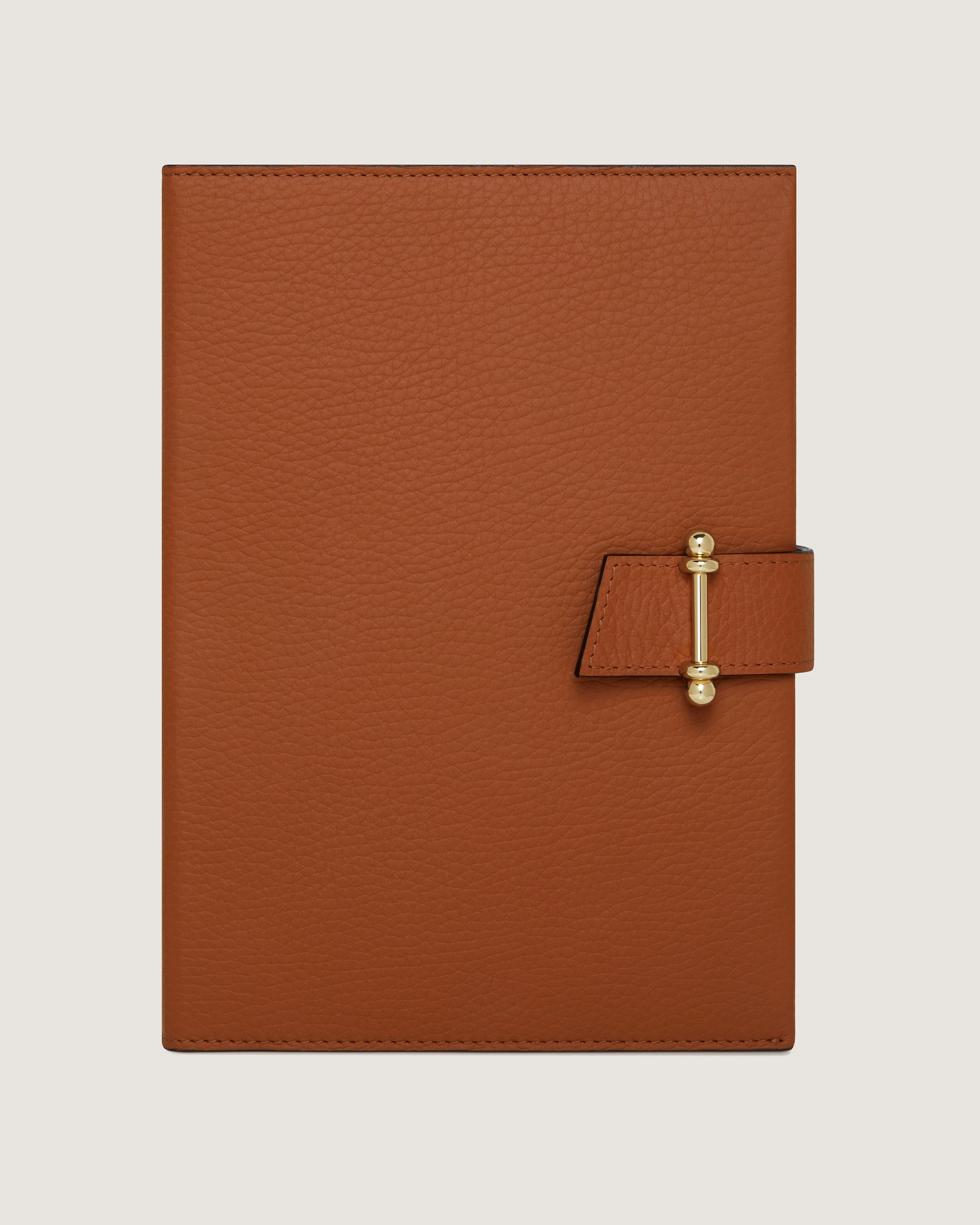 A brown leather notebook with a gold clasp