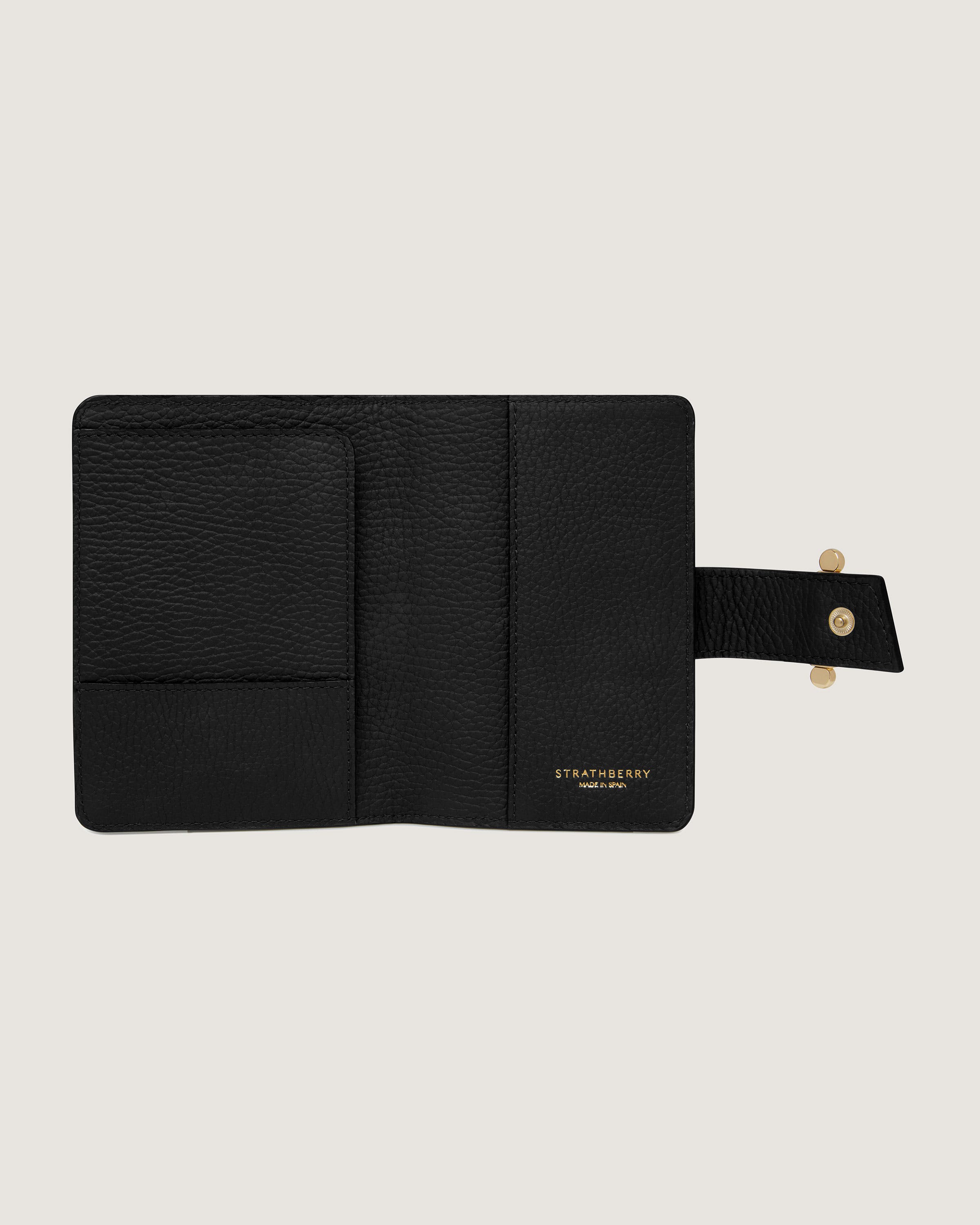 A black leather wallet with a gold clasp