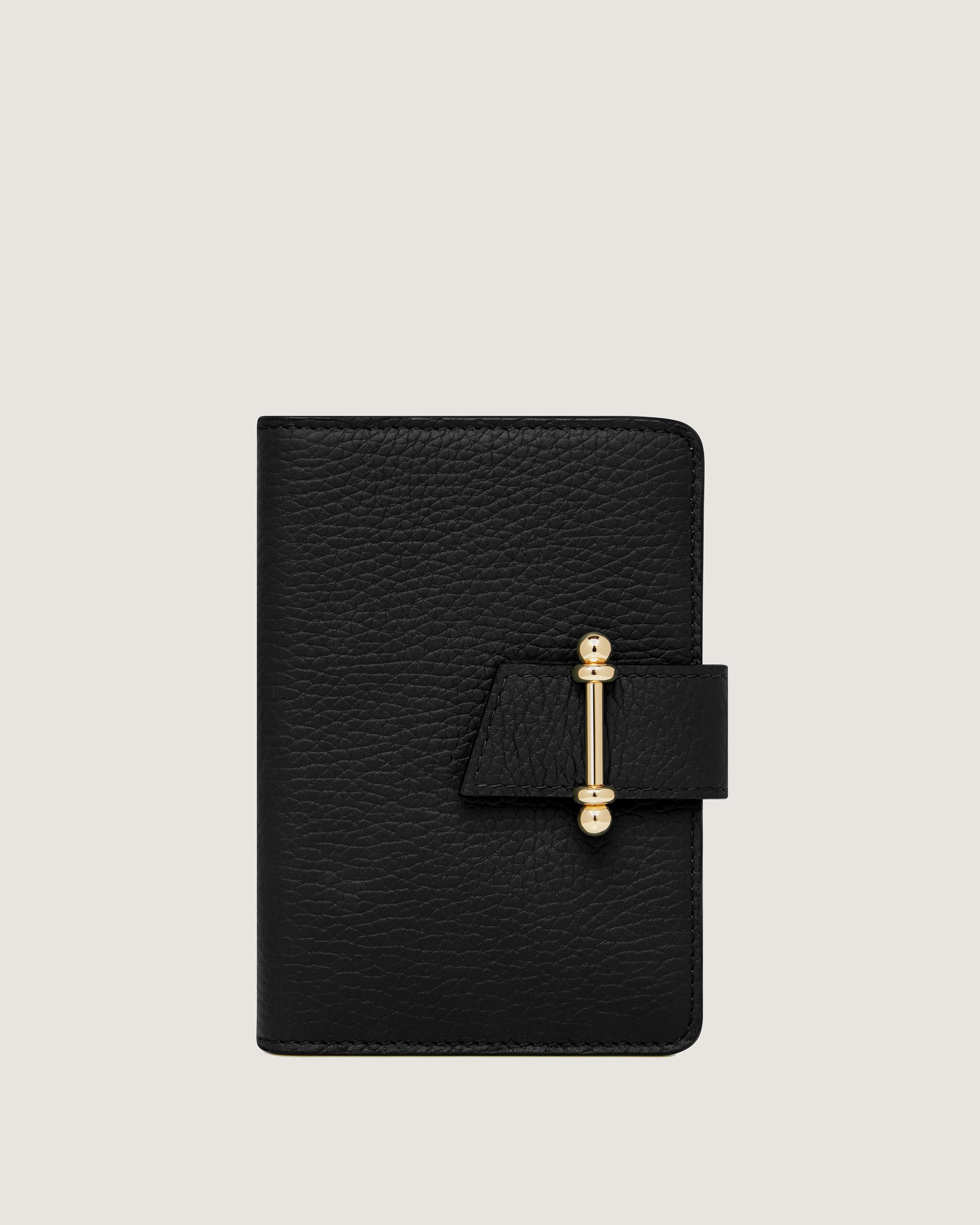 A black leather notebook with a gold clasp