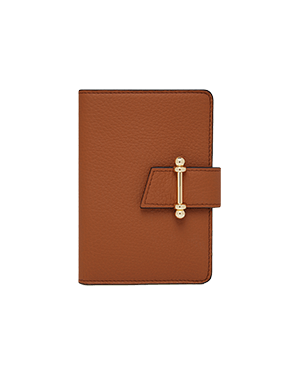 A brown leather notebook with a gold clasp