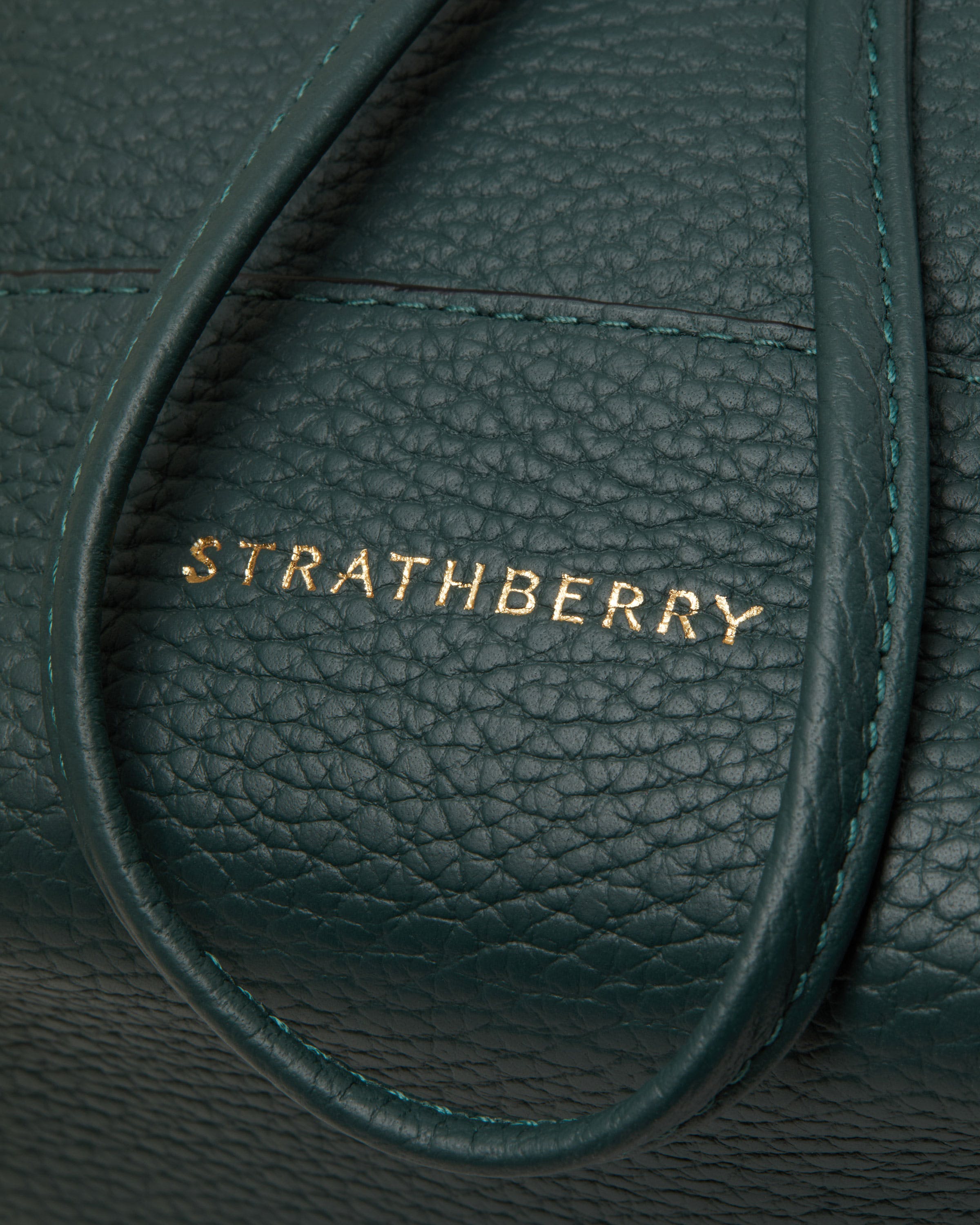 A close up of a green leather bag